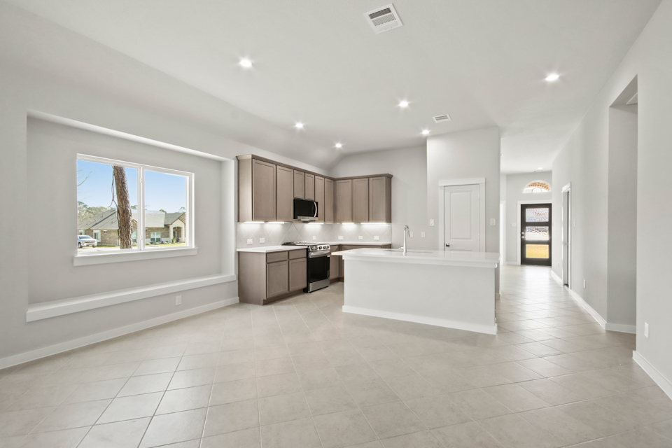 A large kitchen with a large window.