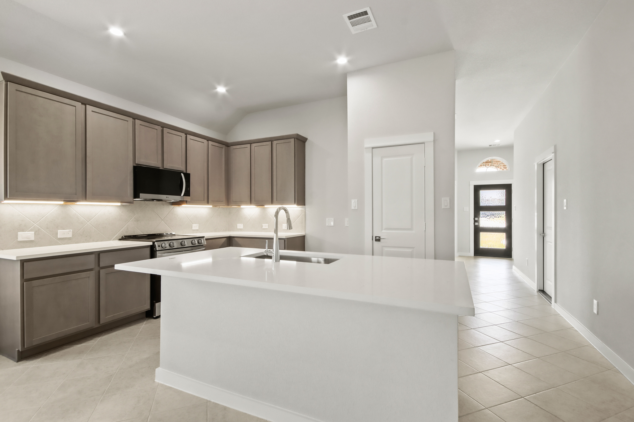 A kitchen with a white counter top.