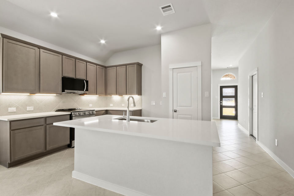 A kitchen with a white counter top.