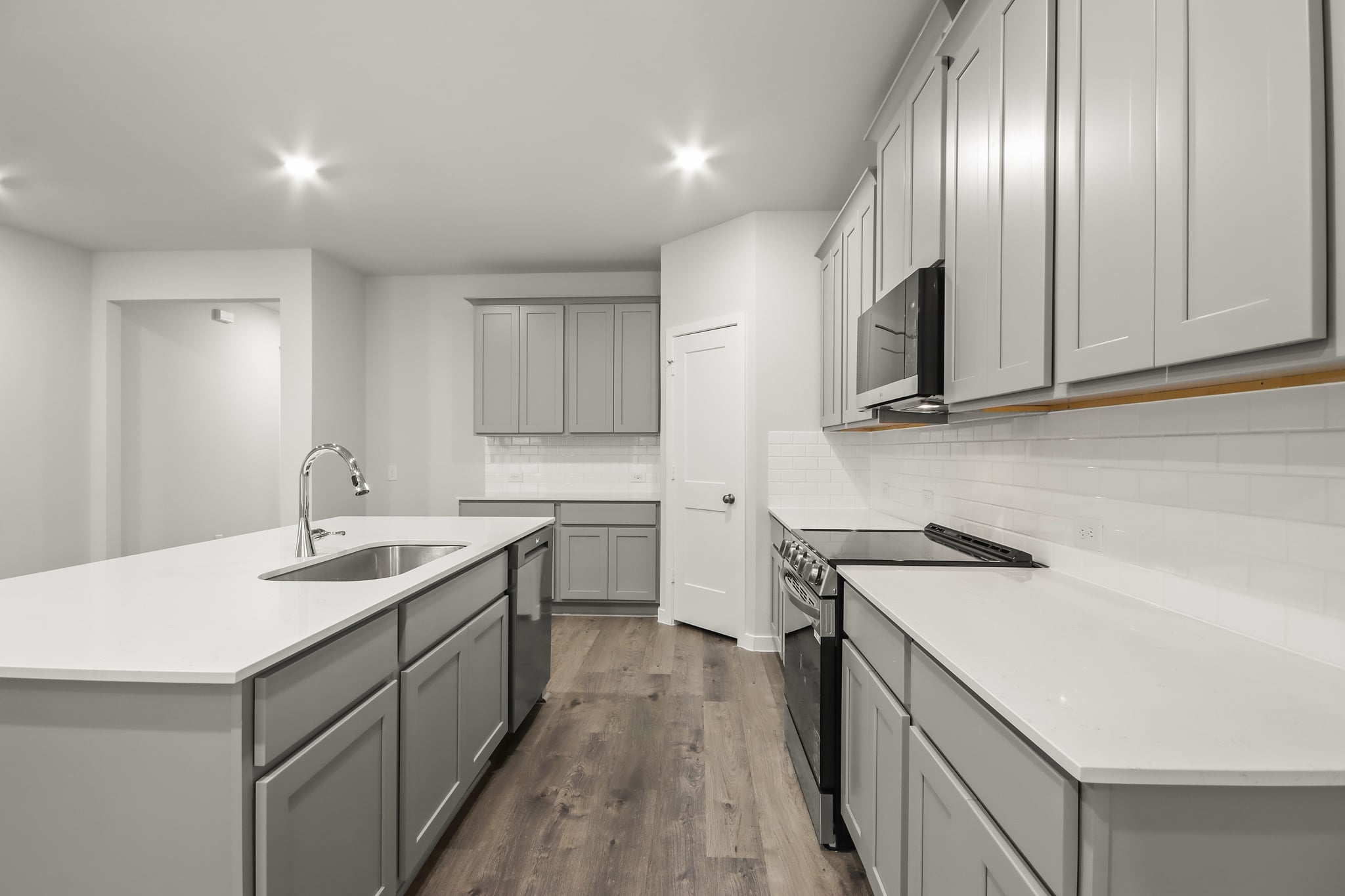 A kitchen with white cabinets.