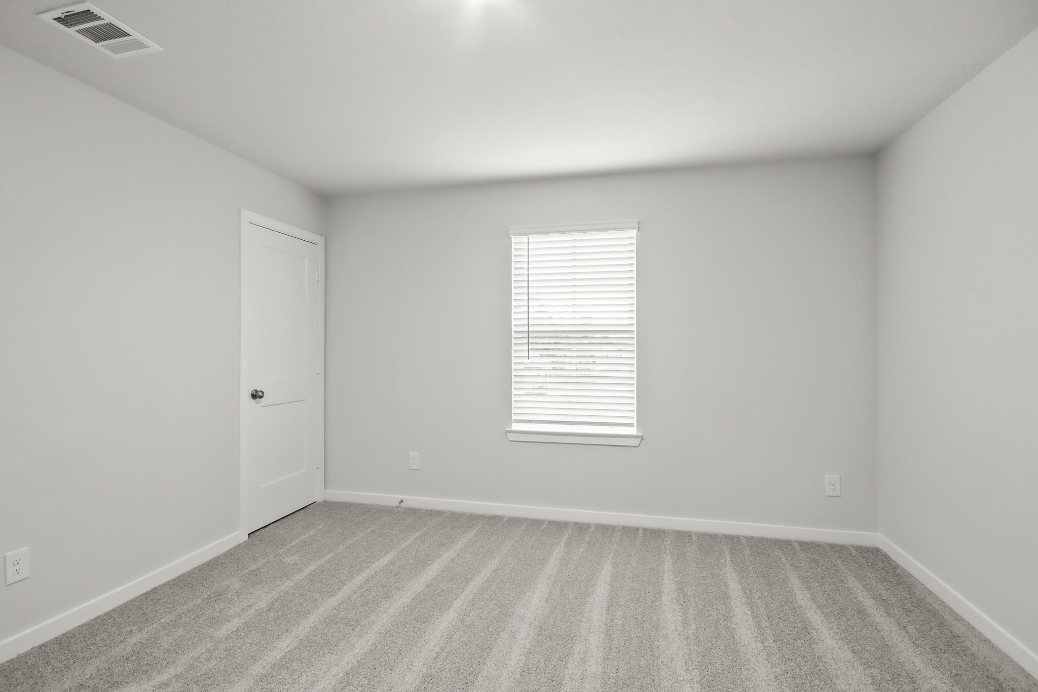 A room with a door and a window.