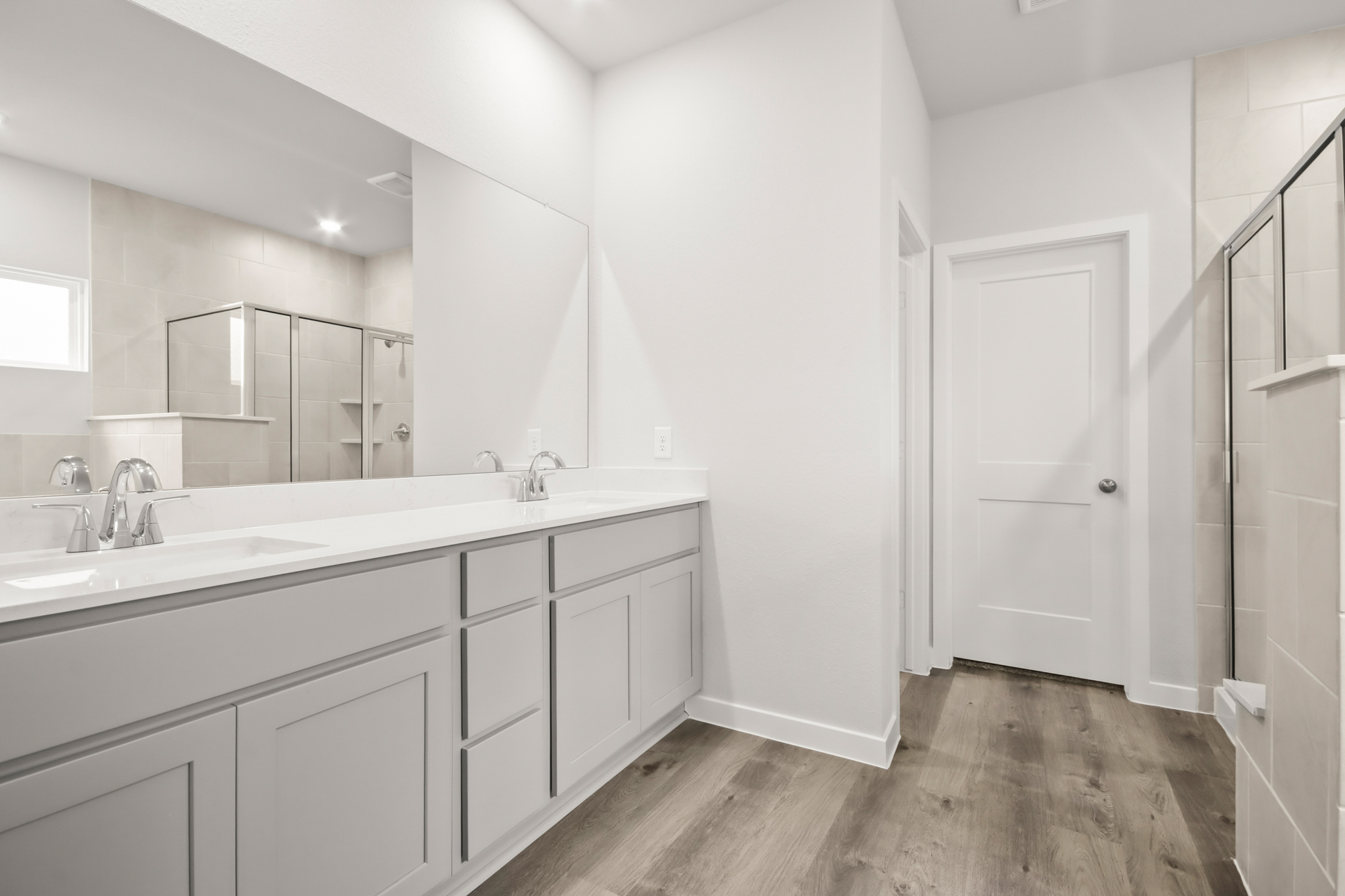 A bathroom with white cabinets.