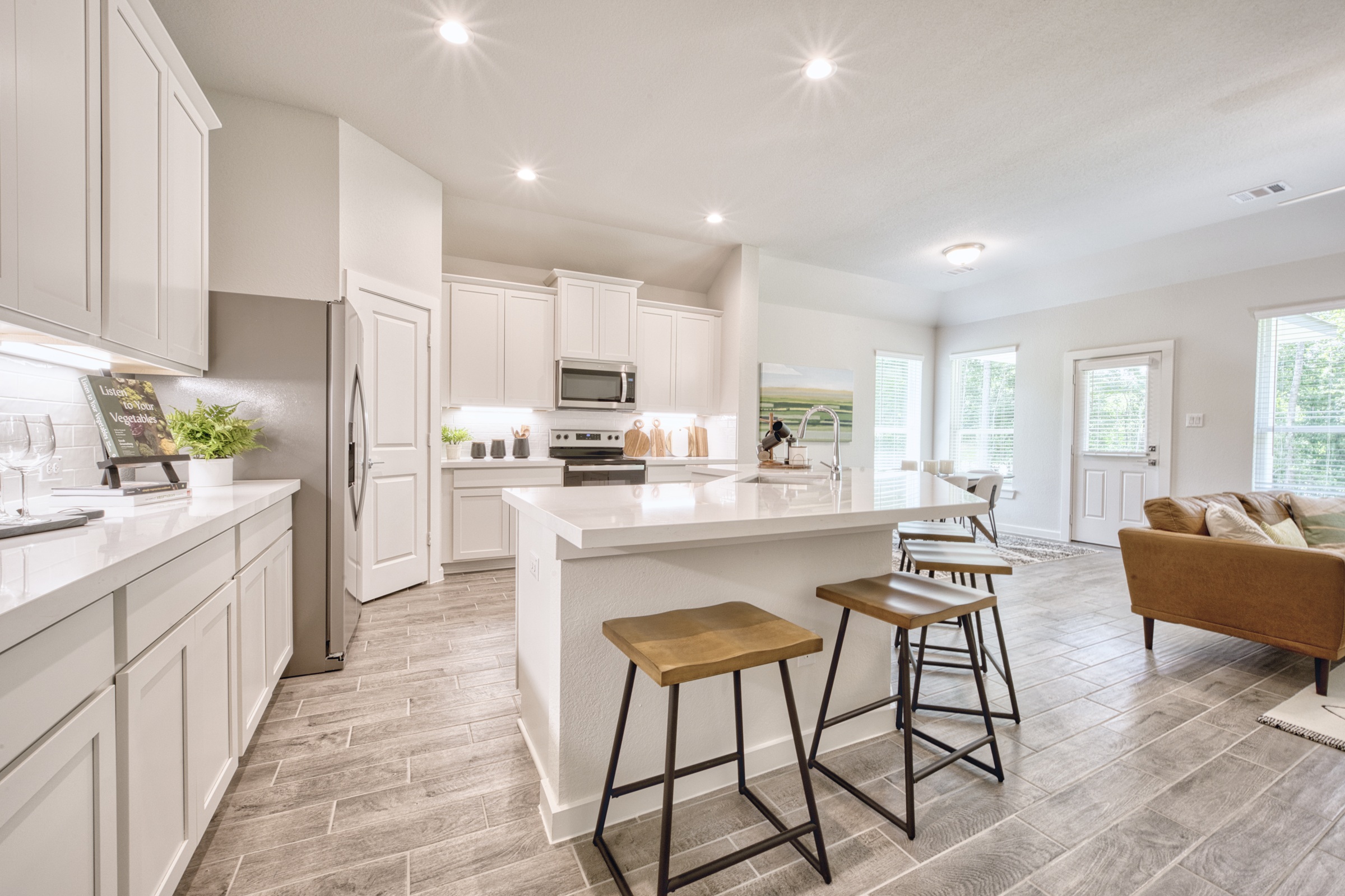 A kitchen with a bar stool and a table.