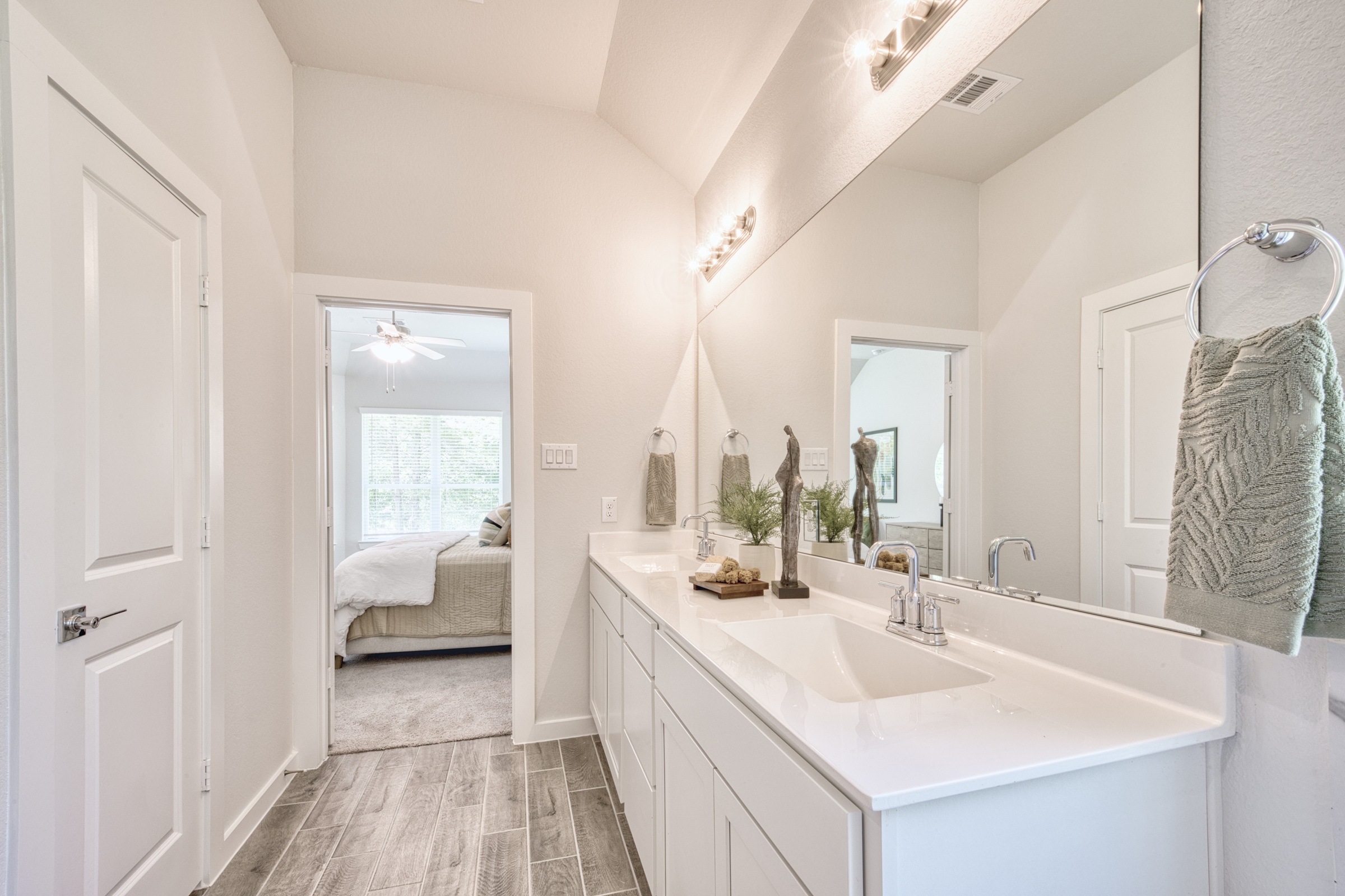 A bathroom with a large mirror.