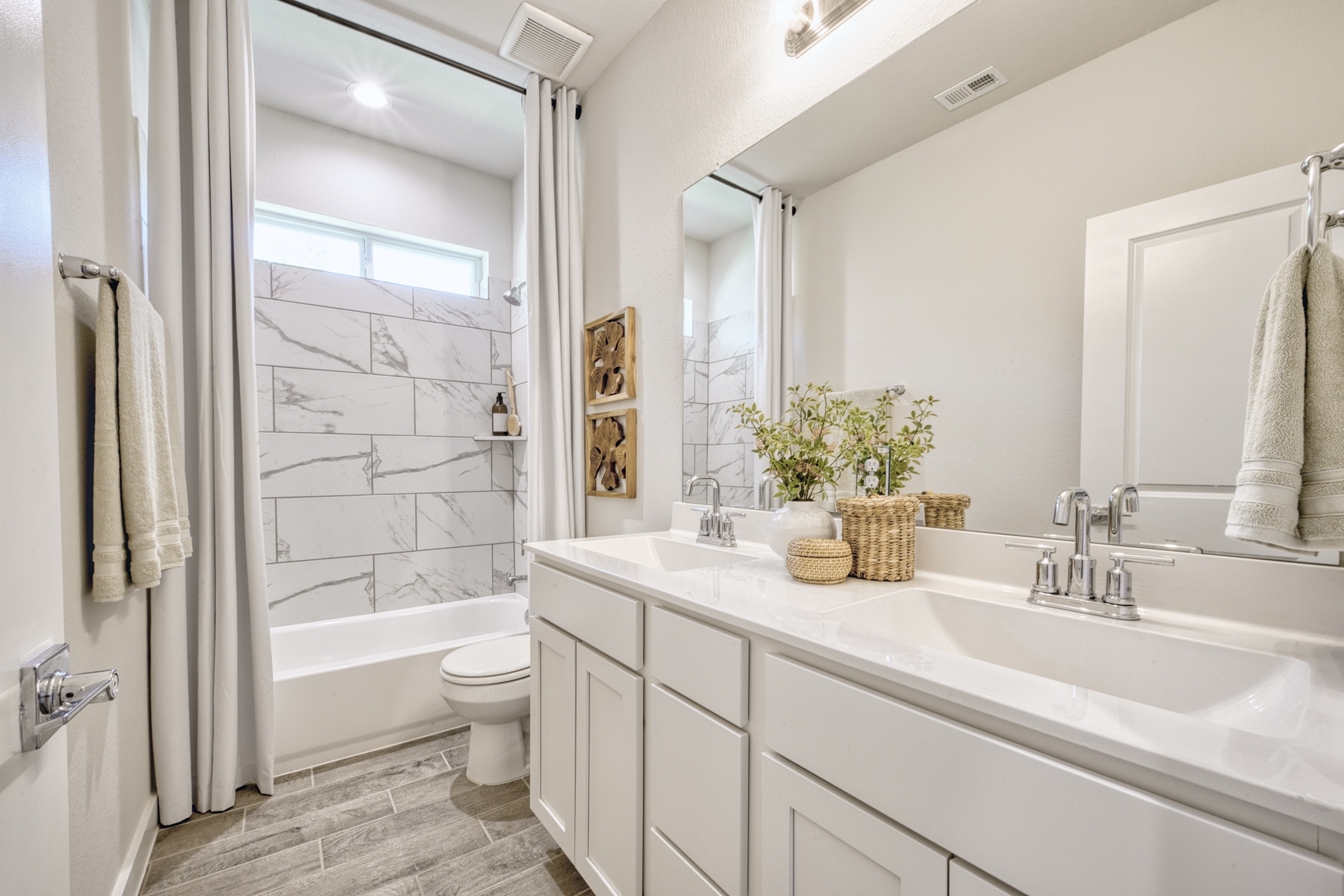 A bathroom with a tub sink and toilet.