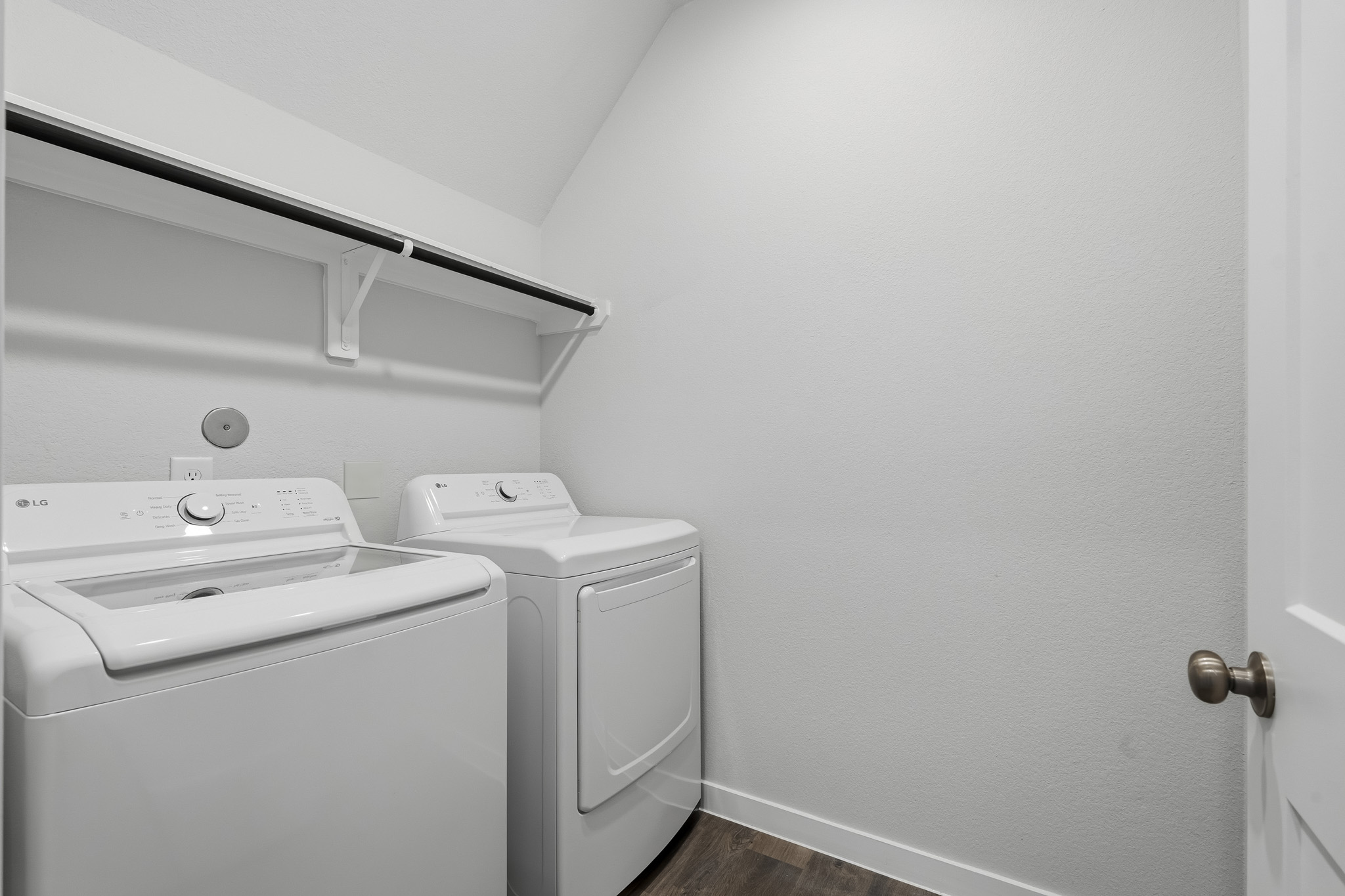 A washing machine and dryer in a room.