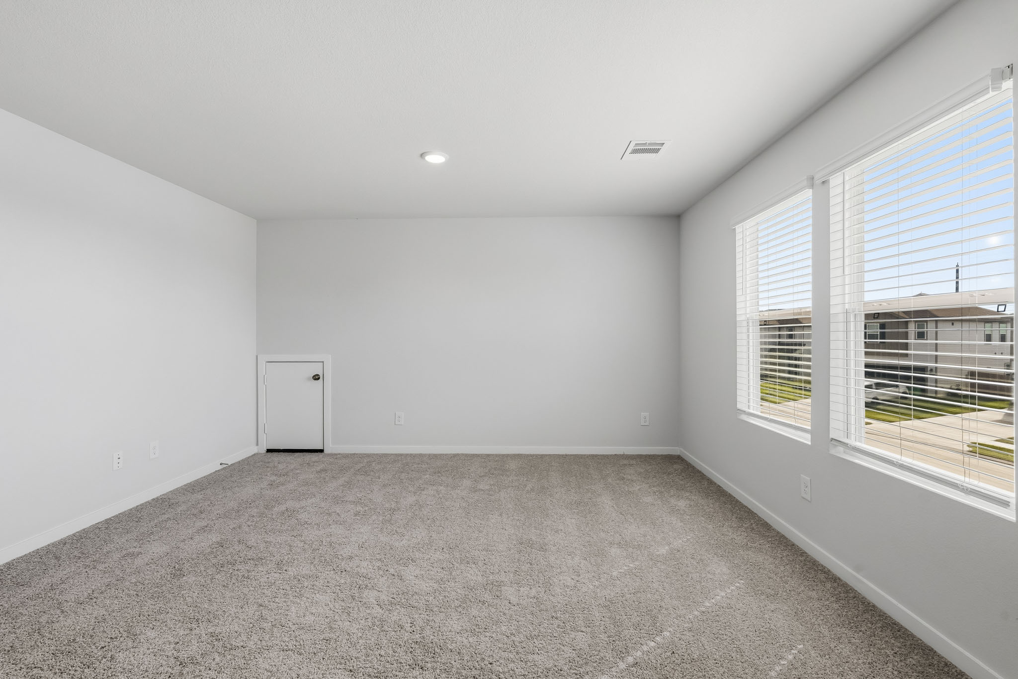 A room with a window and a door.