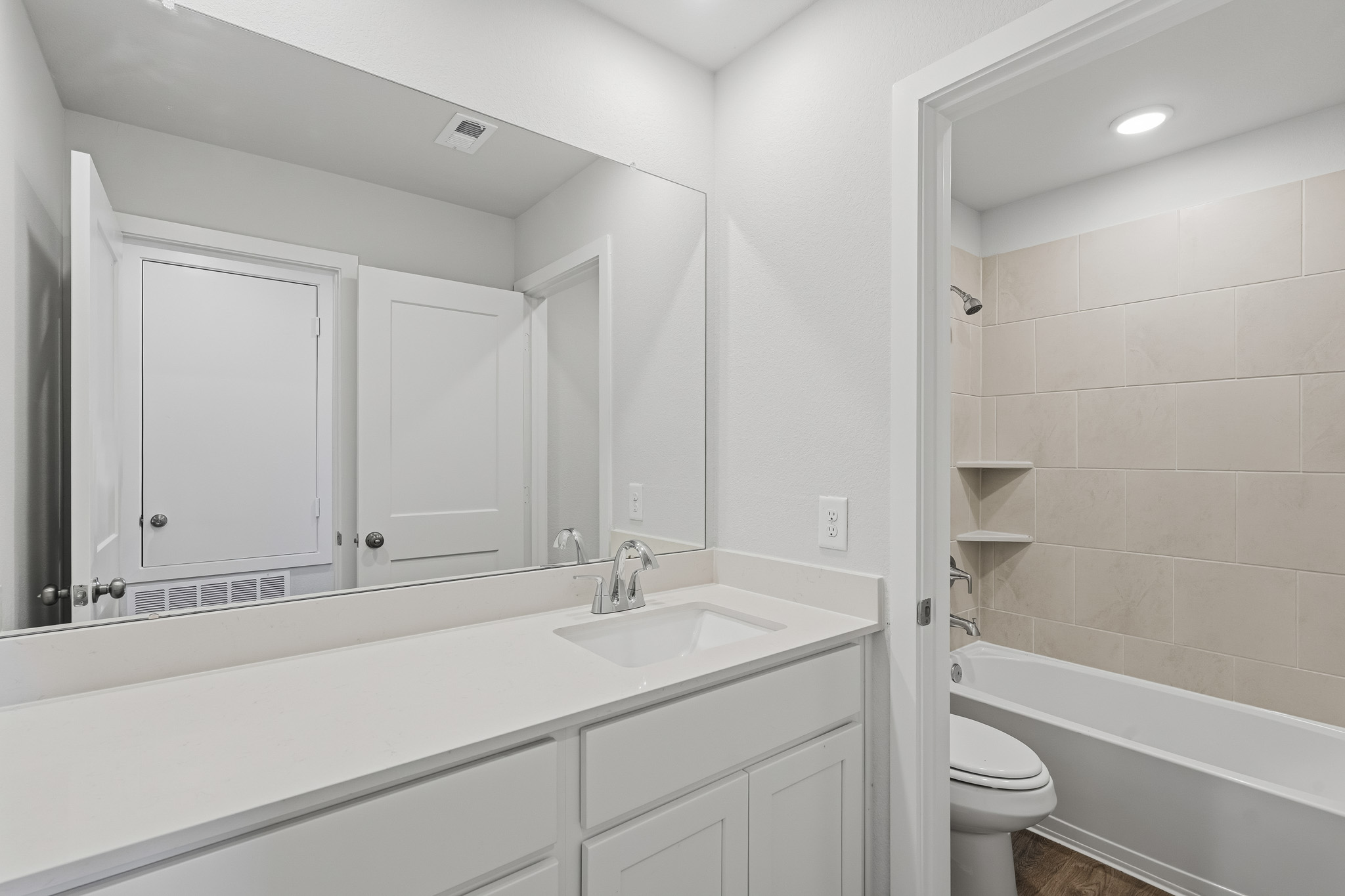 A bathroom with a sink toilet and bathtub.