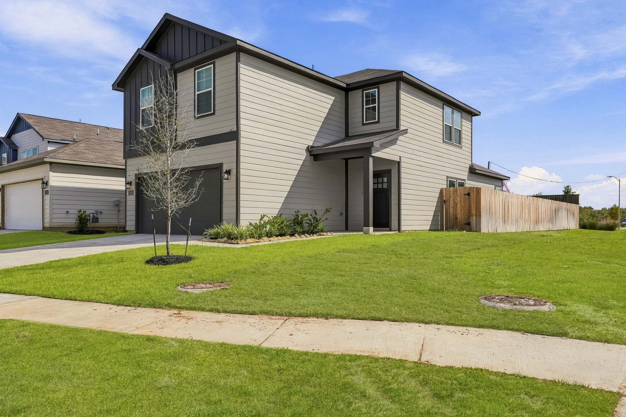 A house with a fence and yard.