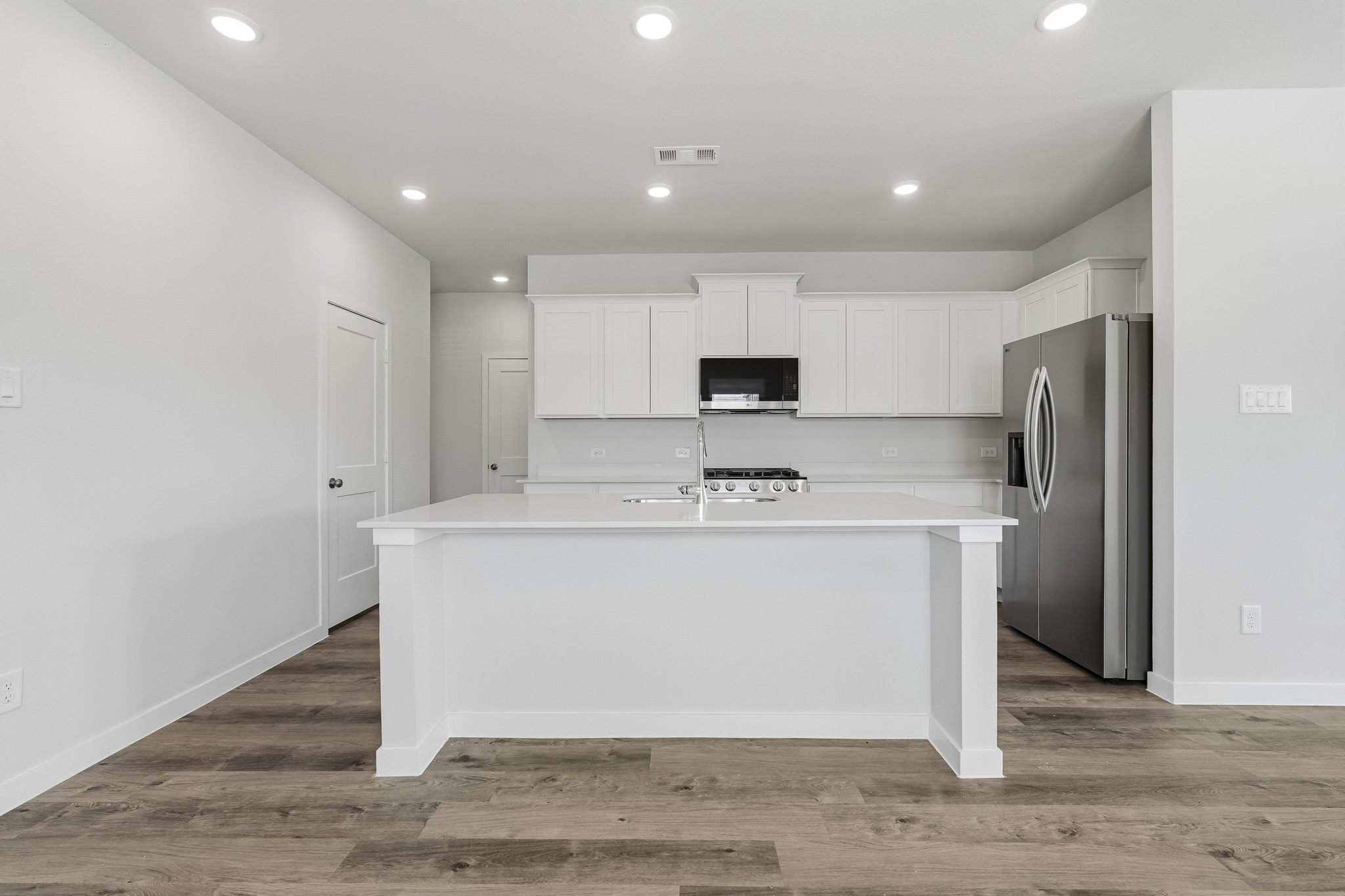 A kitchen with white cabinets.