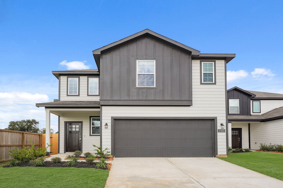 A grey house with a garage.