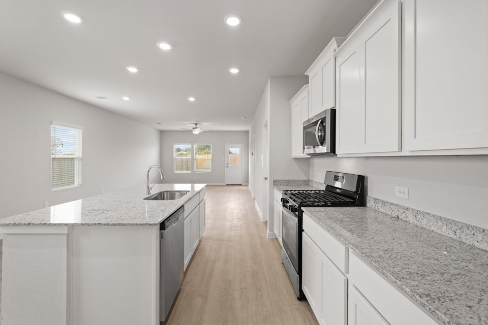 A kitchen with white cabinets.