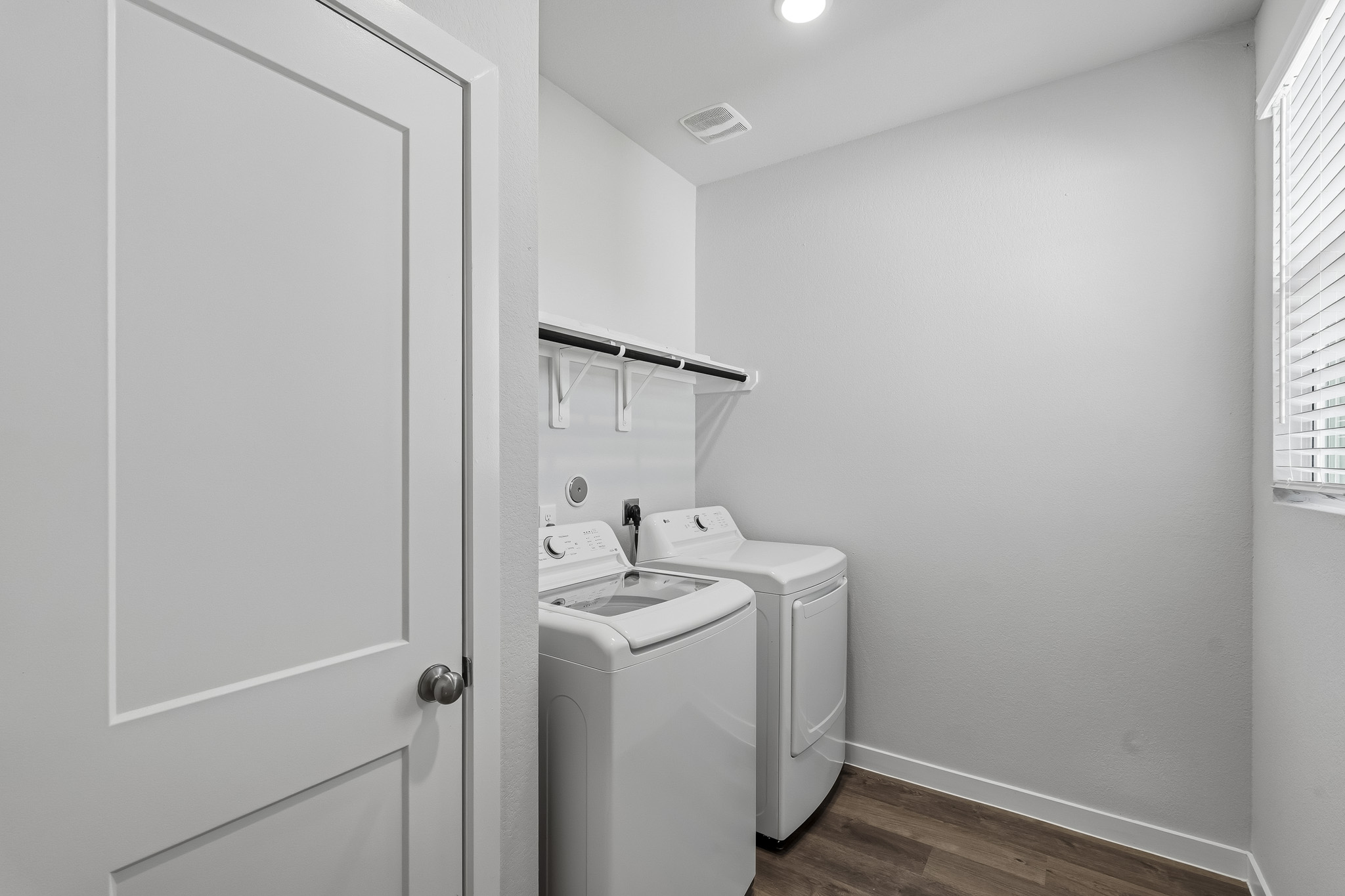 A small bathroom with a washer and dryer.