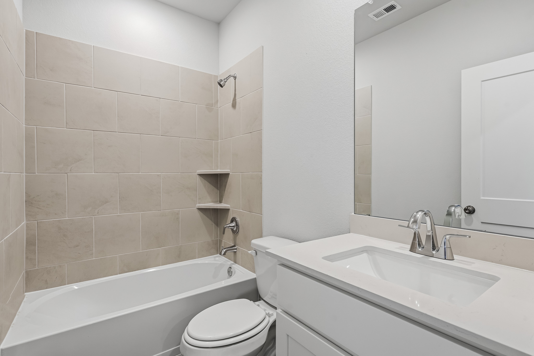 A bathroom with a tub sink and toilet.