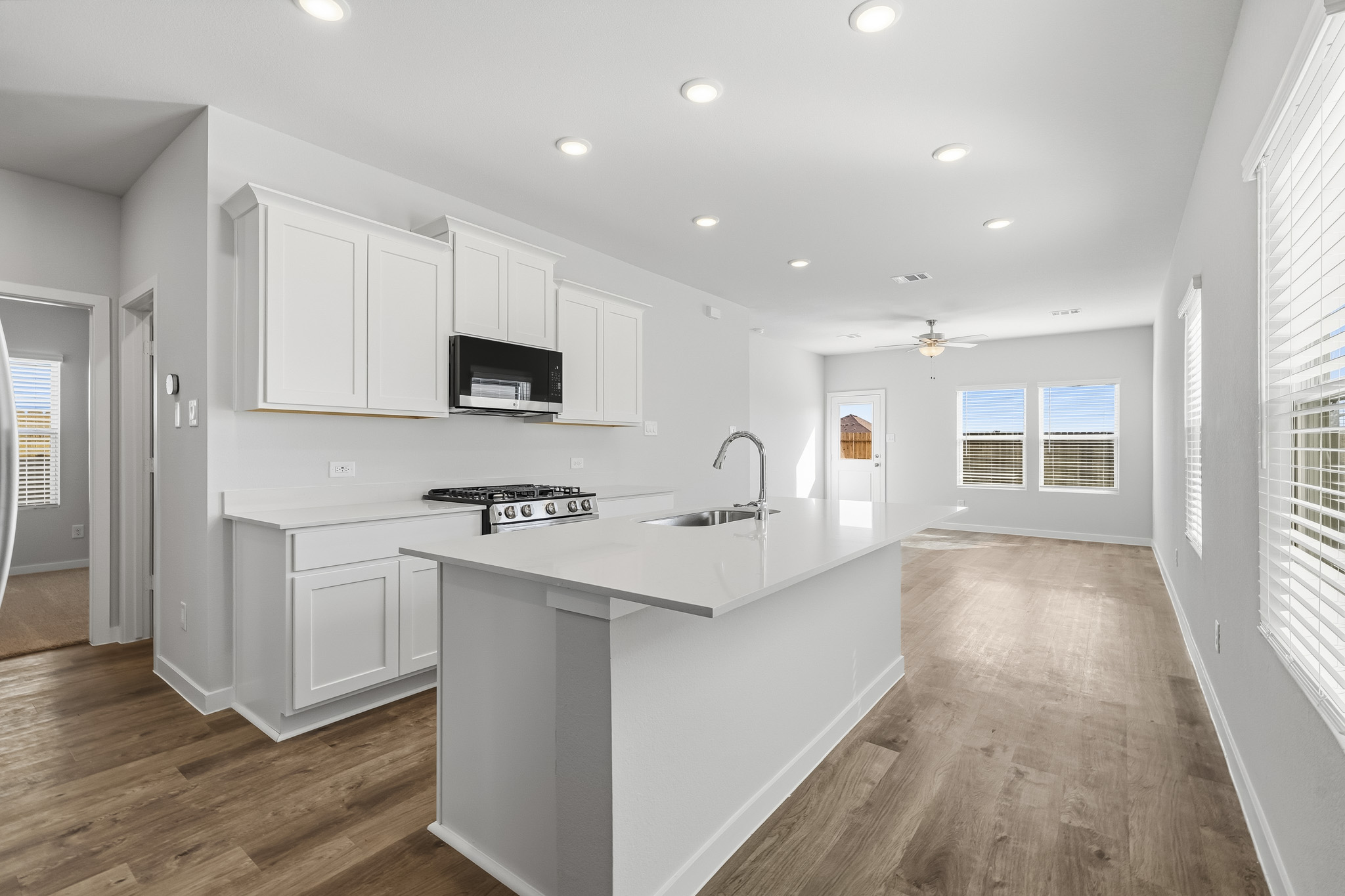 A kitchen with white cabinets.