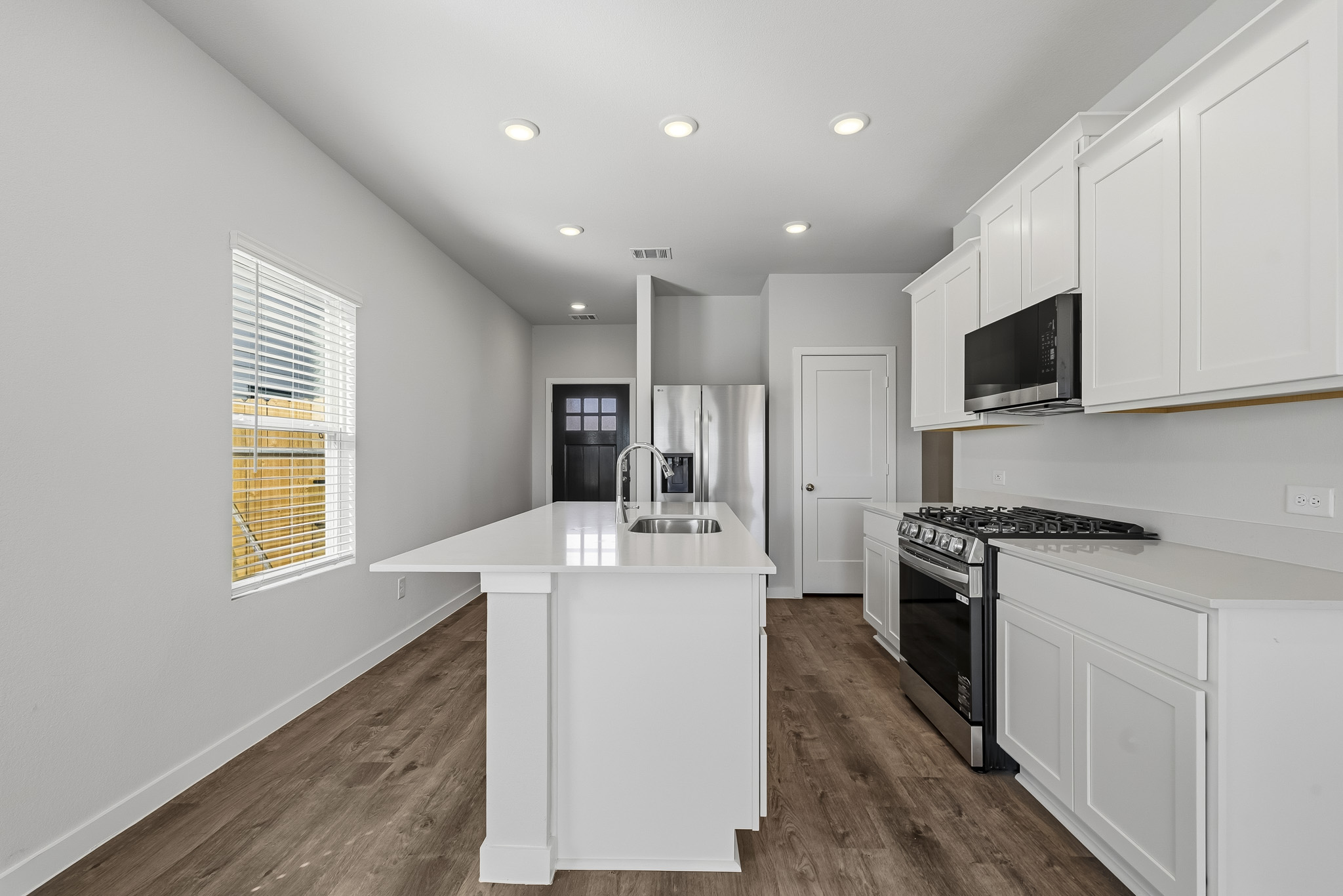 A kitchen with white cabinets.