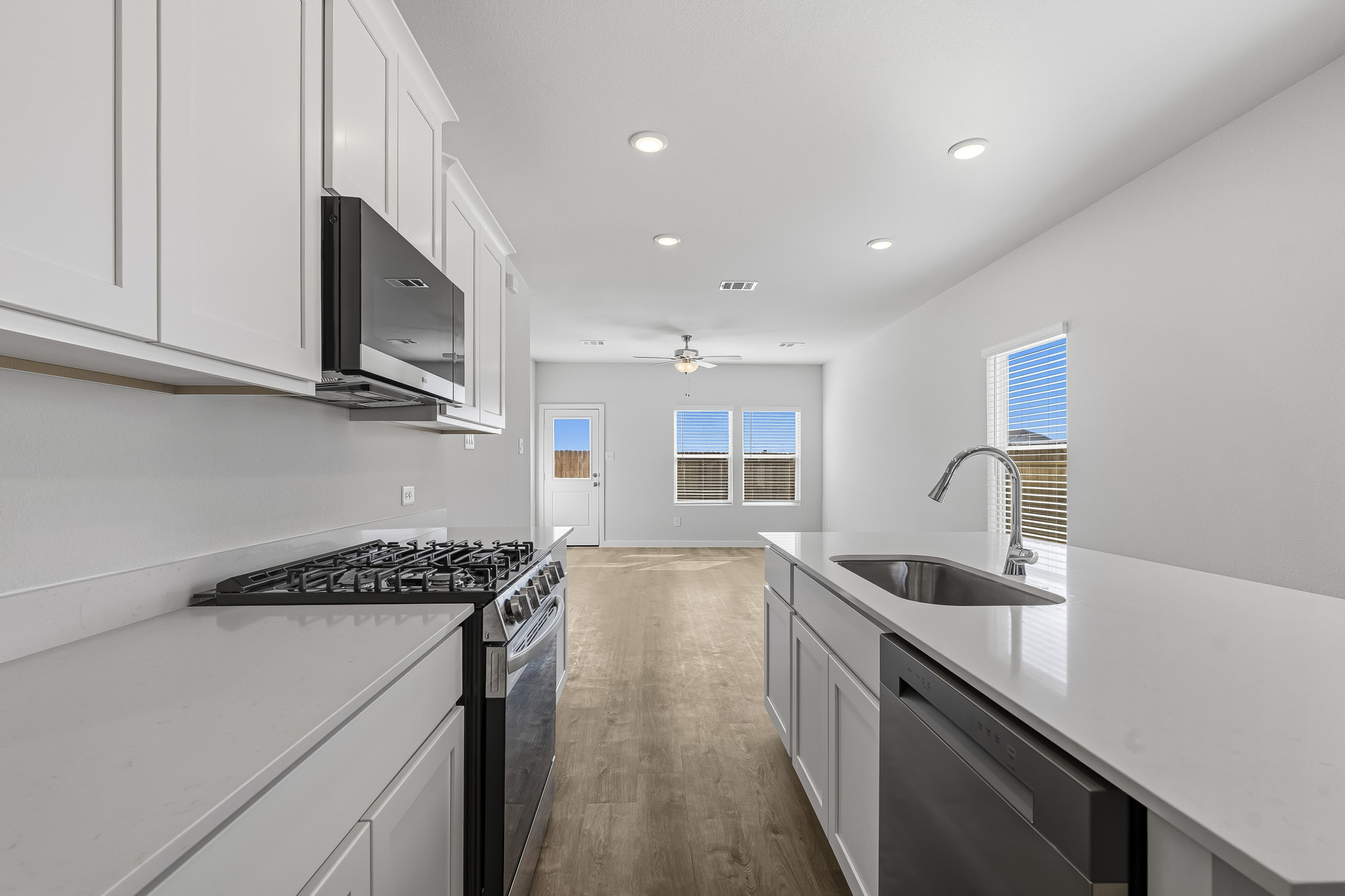 A kitchen with white cabinets.