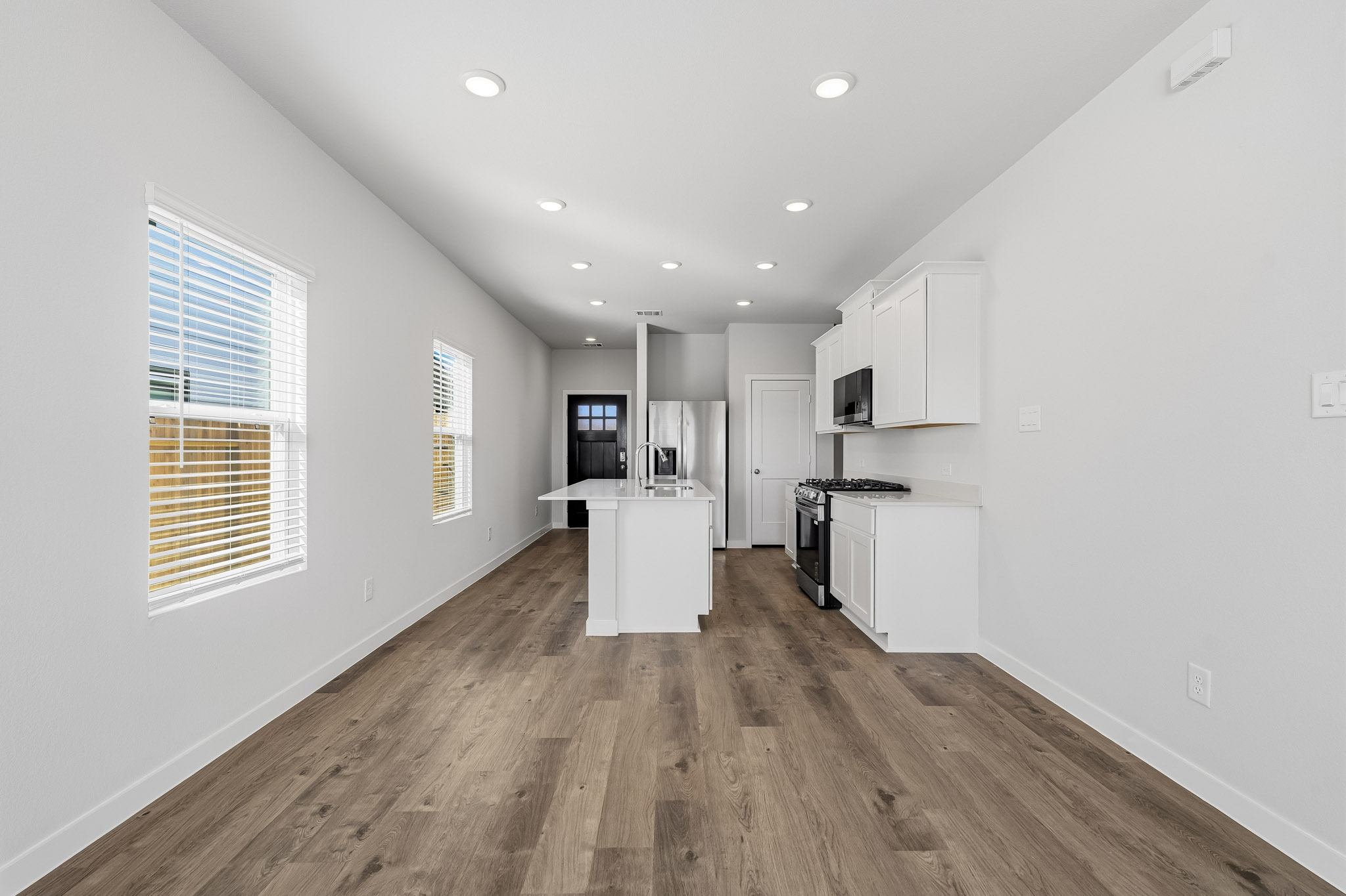 A kitchen with white walls.