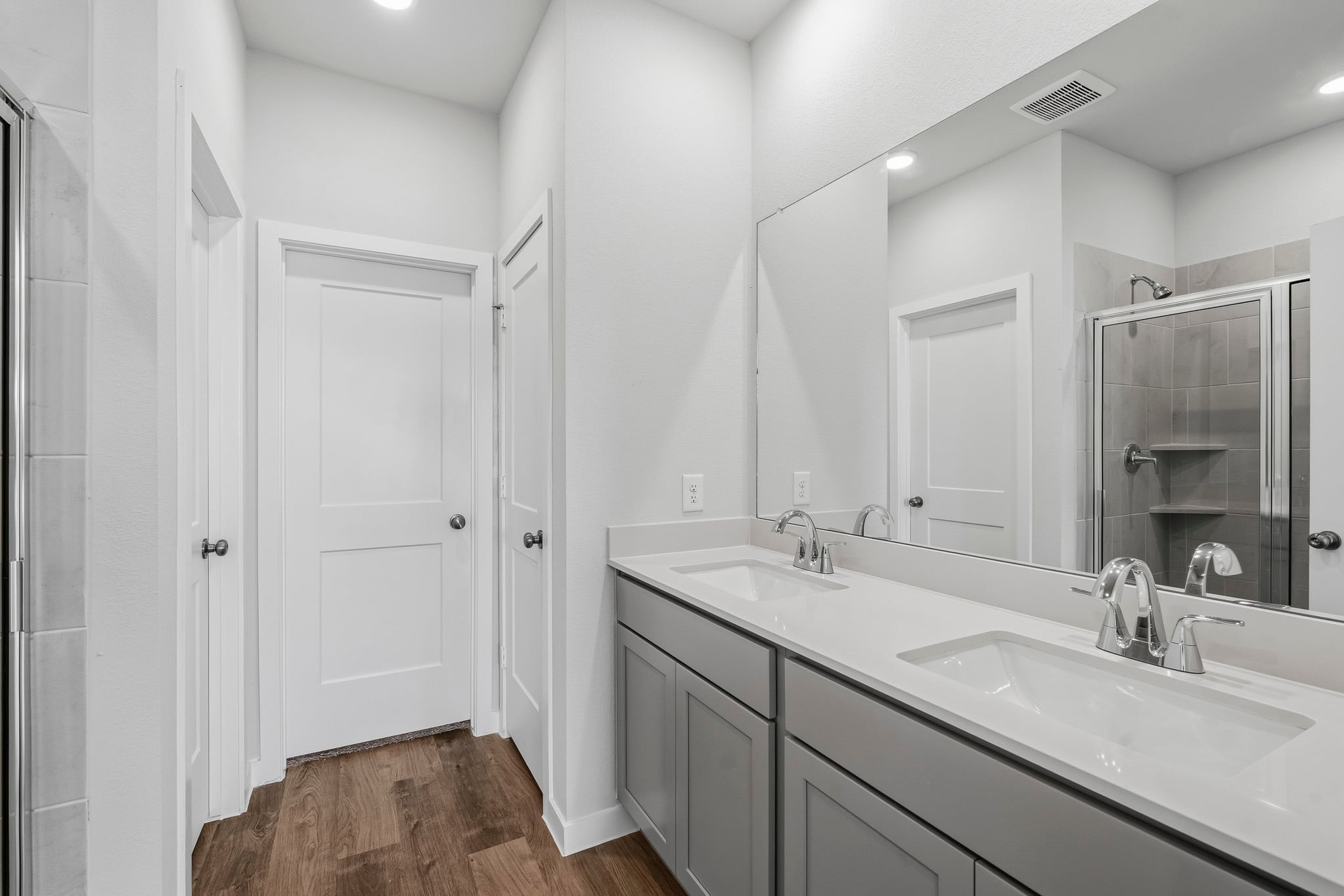 A bathroom with a large mirror.