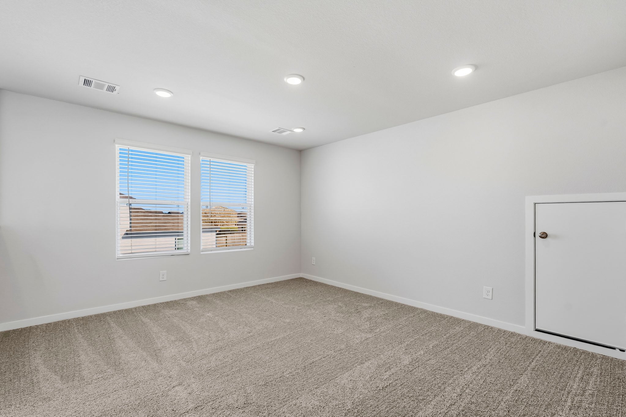 A room with a window and a door.