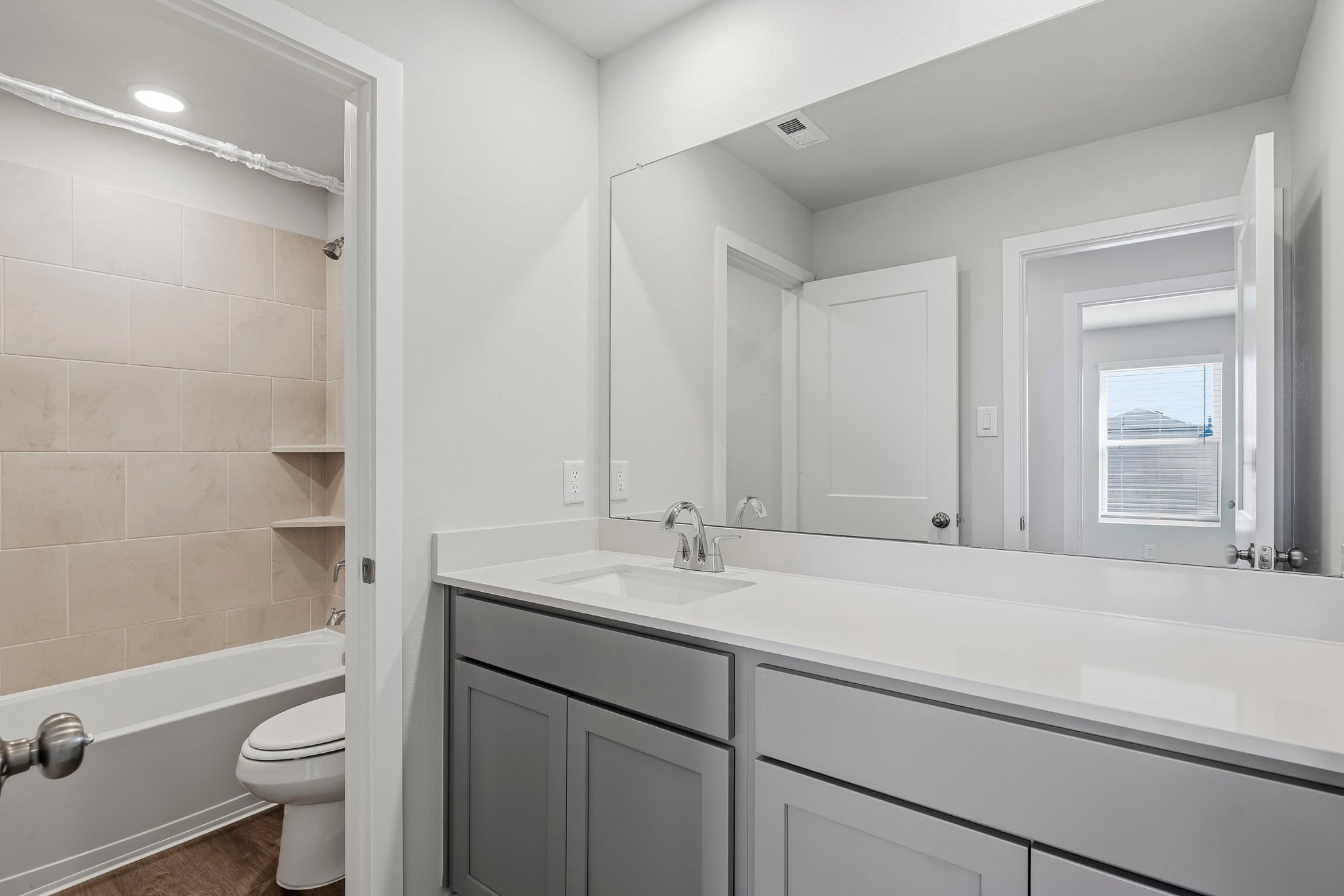 A bathroom with a tub sink and toilet.