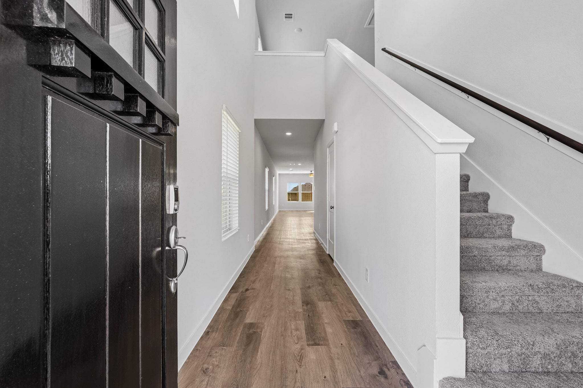 A hallway with a wood floor.