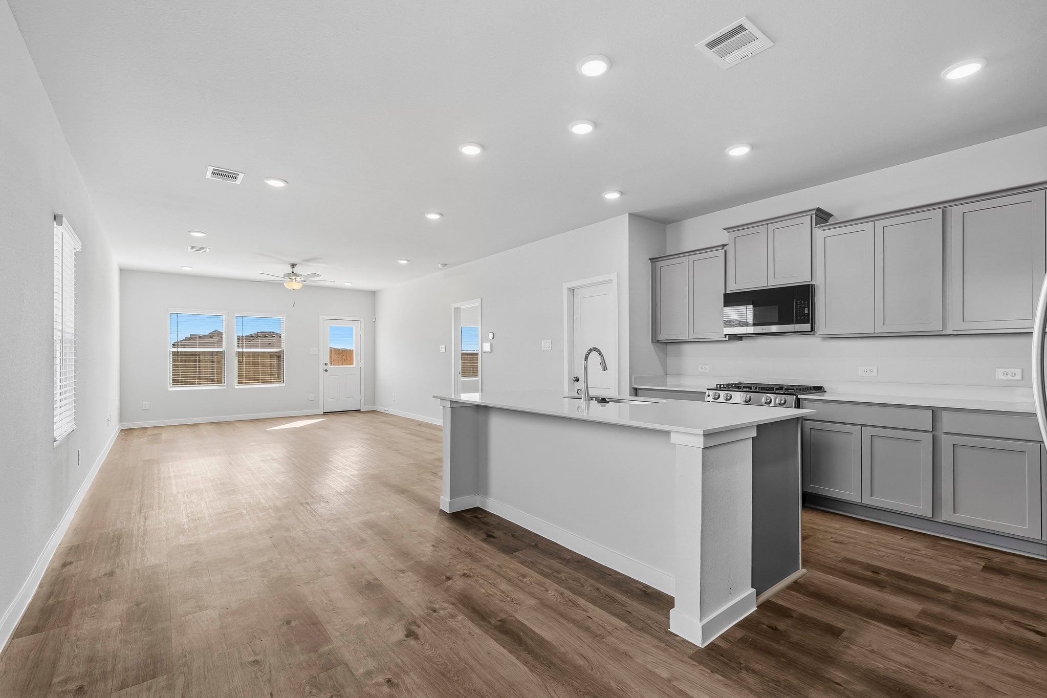 A kitchen with white cabinets.