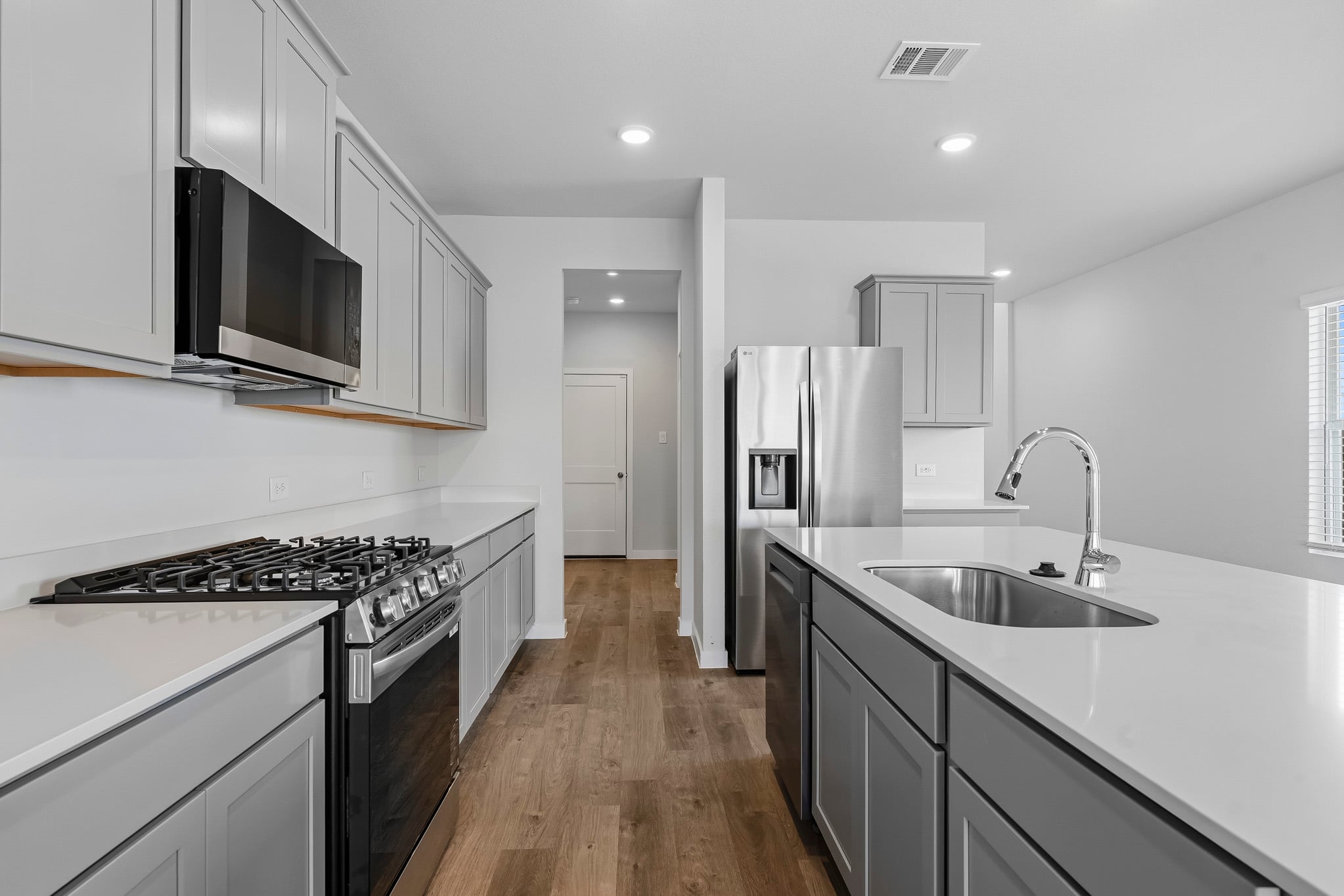 A kitchen with white cabinets.