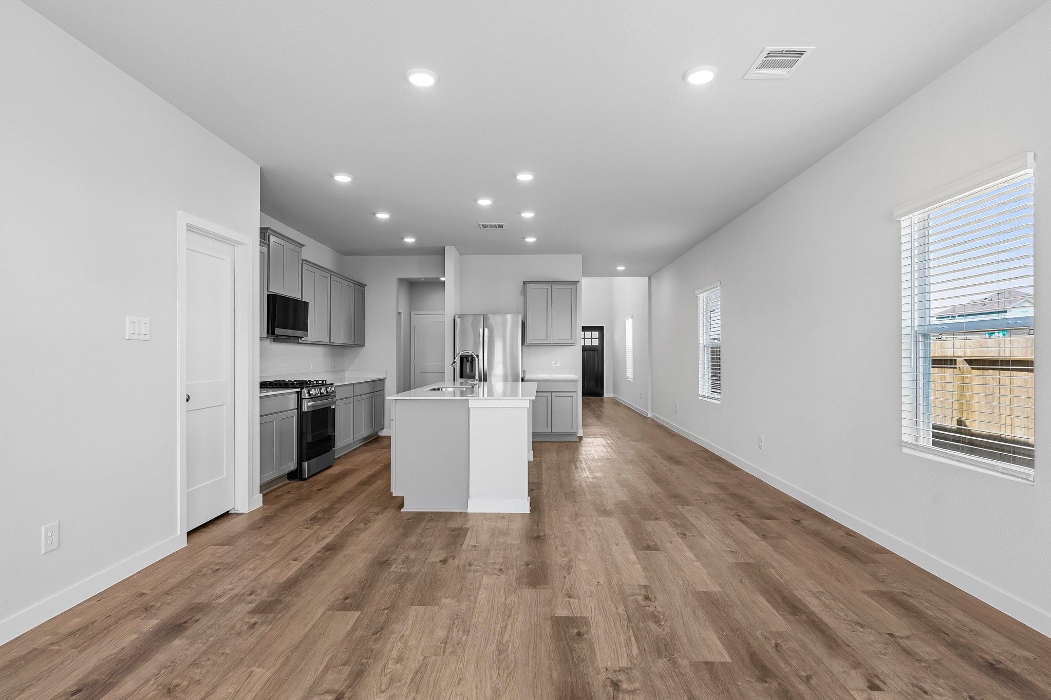A large kitchen with white walls.
