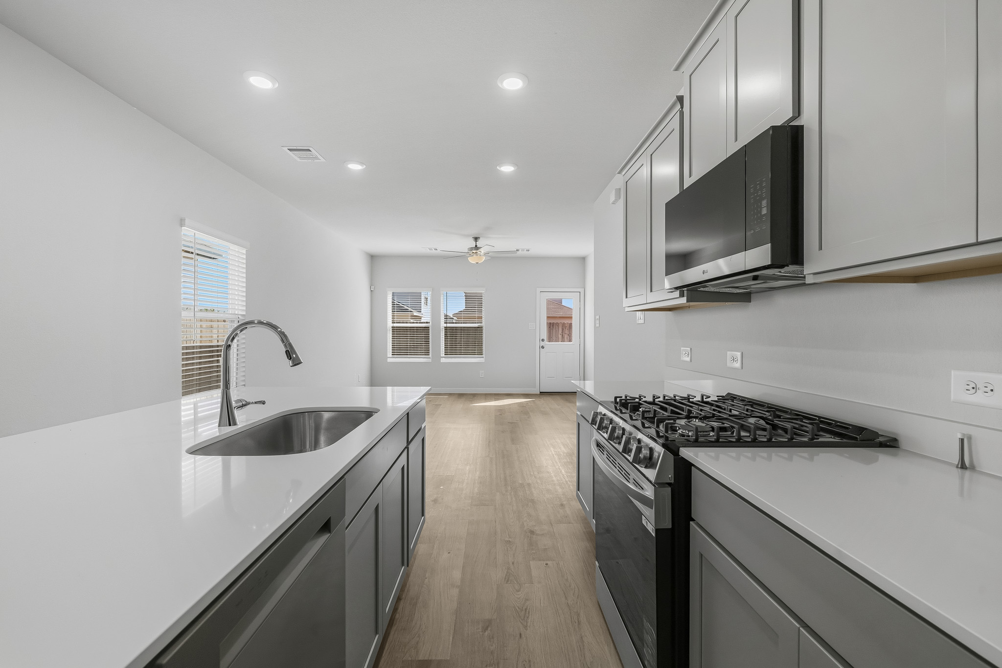 A kitchen with white cabinets.