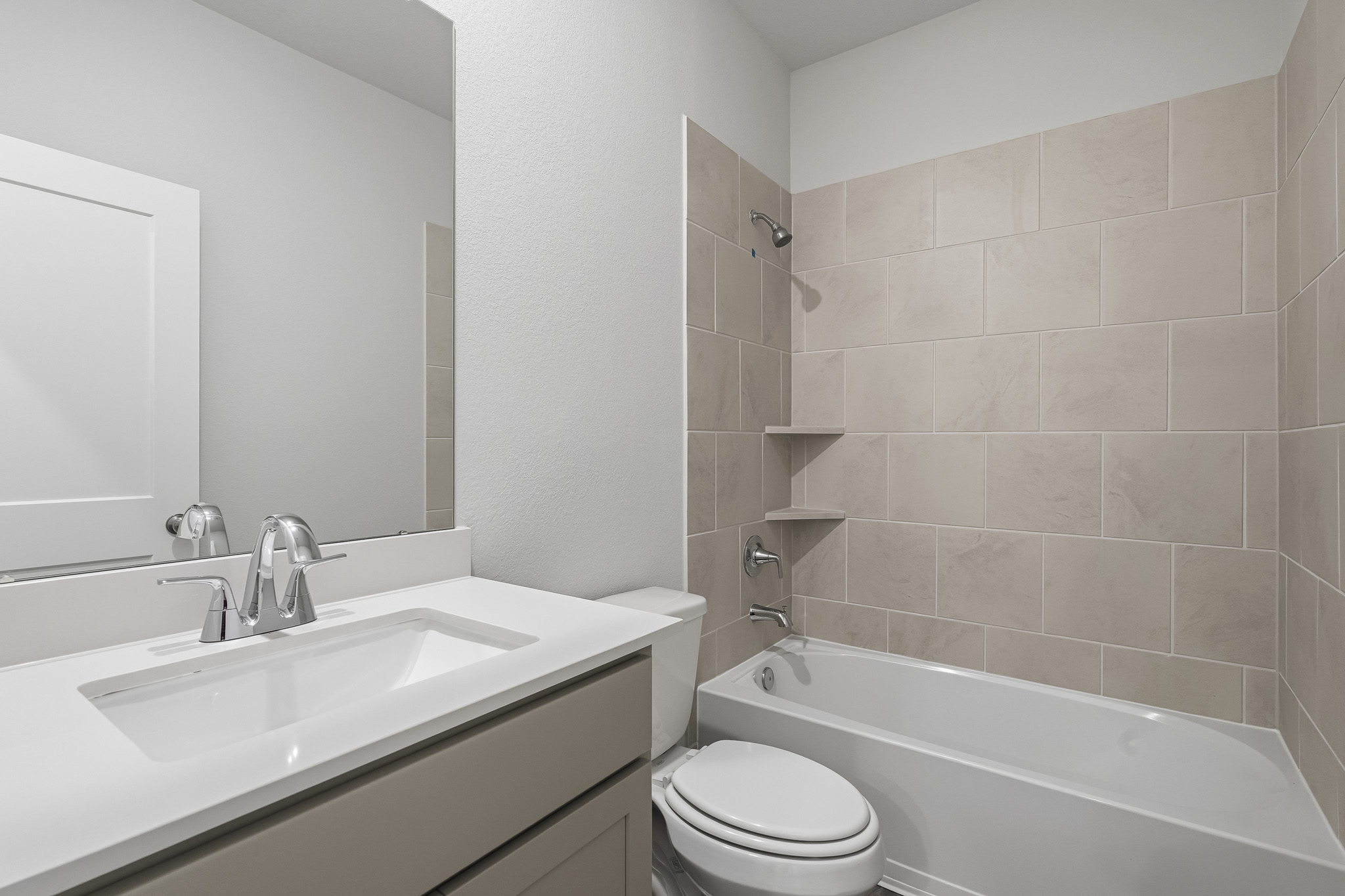 A bathroom with a tub sink and toilet.