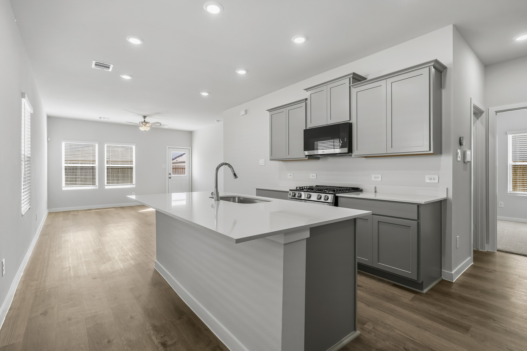 A kitchen with white cabinets.