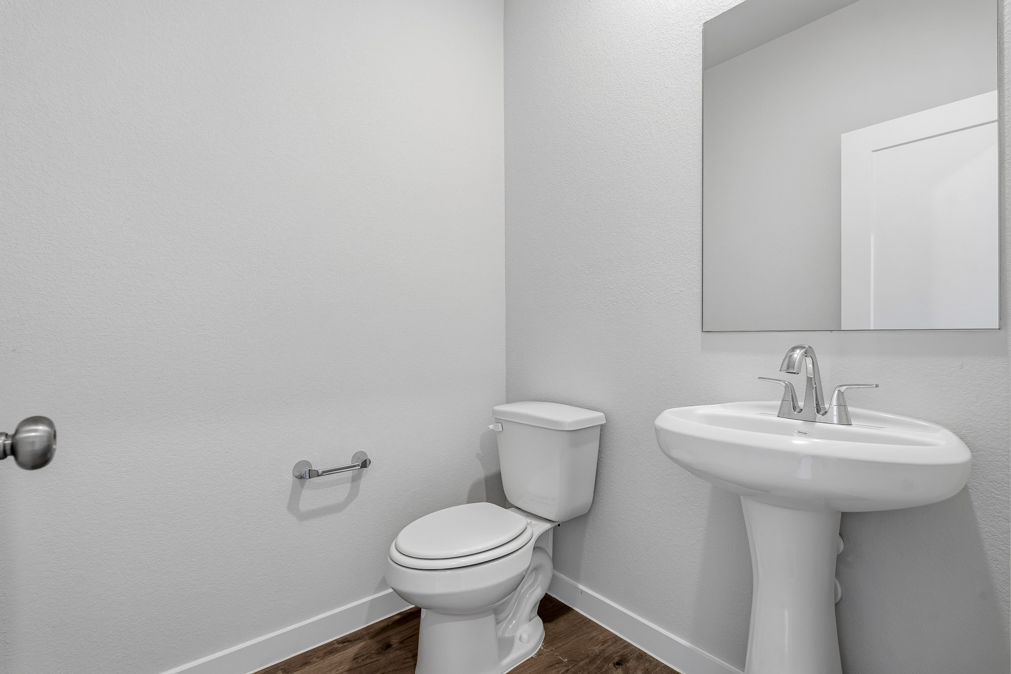 A bathroom with a toilet and sink.