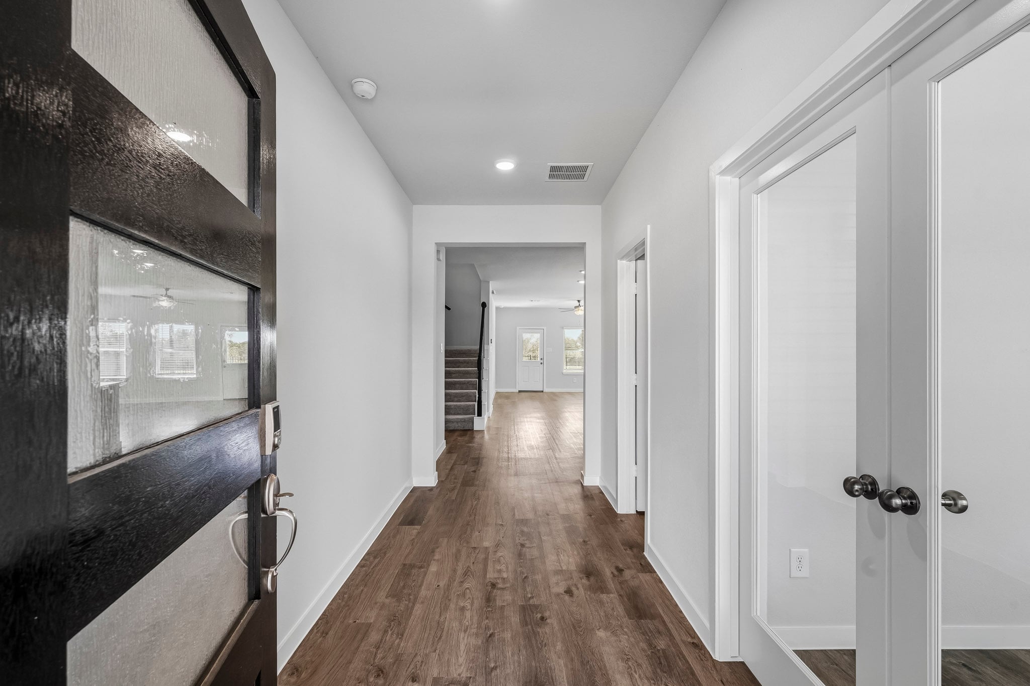 A hallway with white doors.