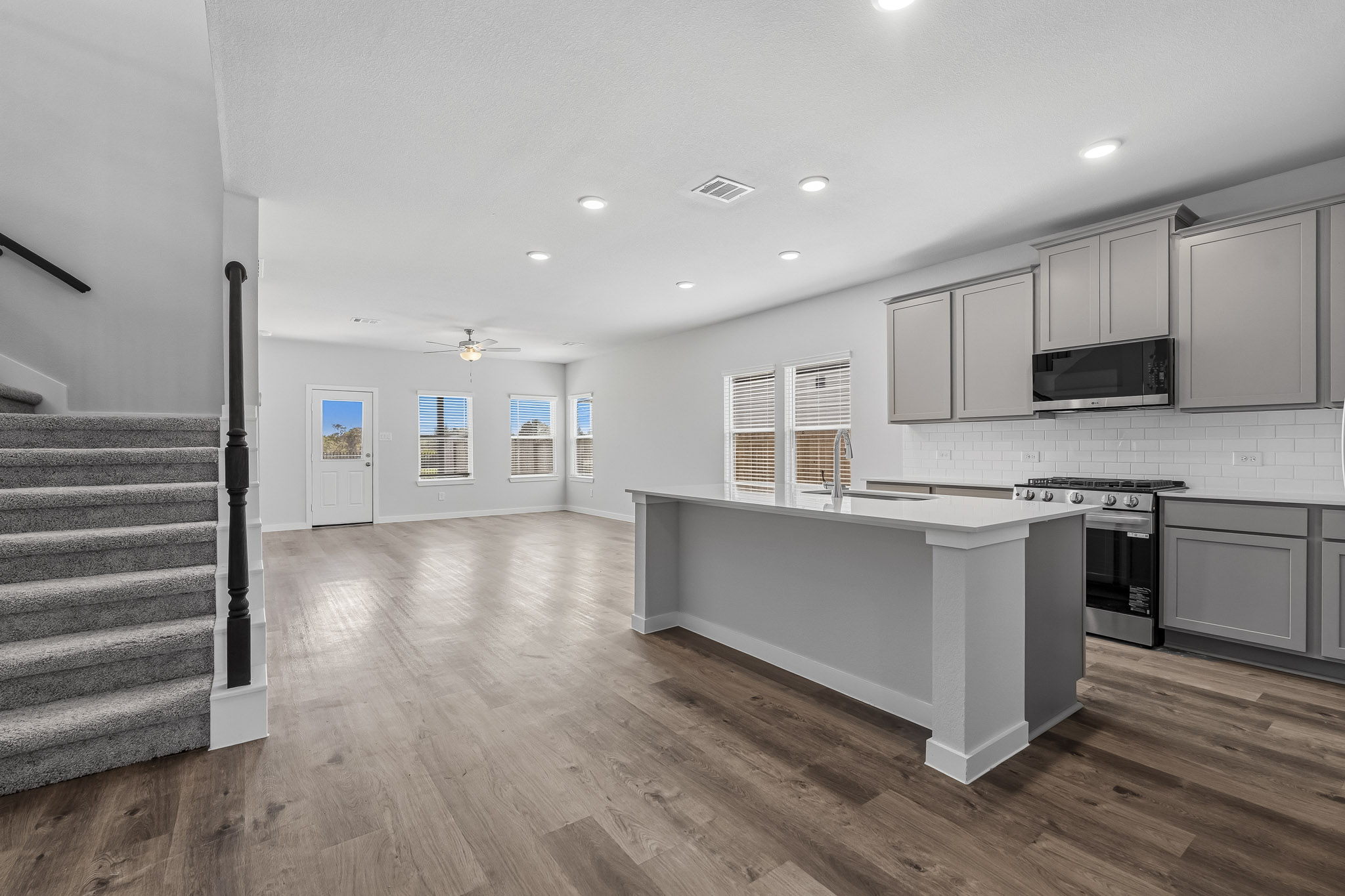 A kitchen with white cabinets.