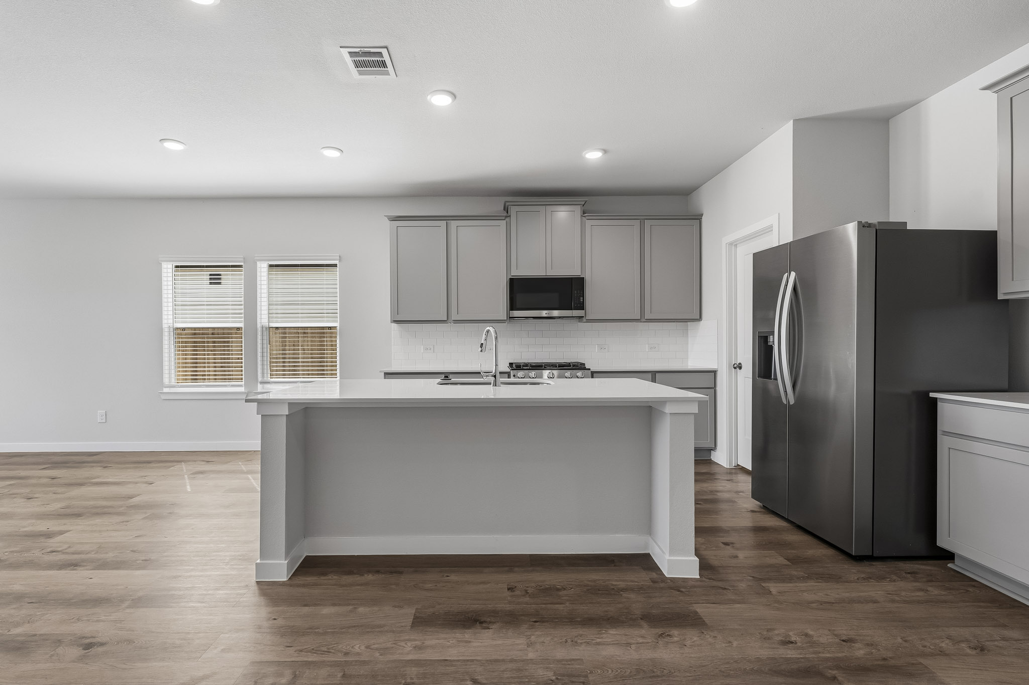 A kitchen with white cabinets.