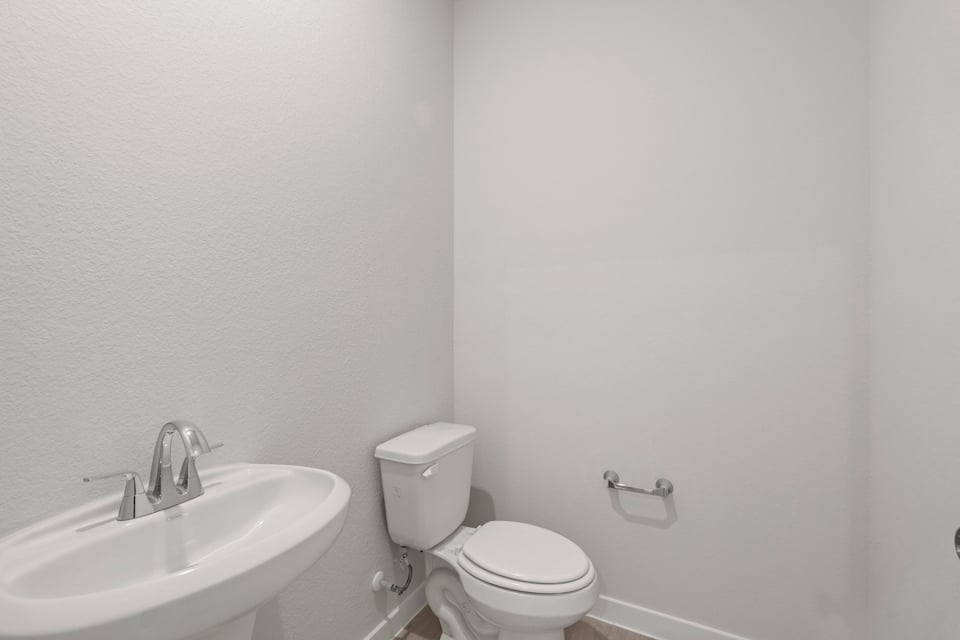 A bathroom with a toilet and sink.
