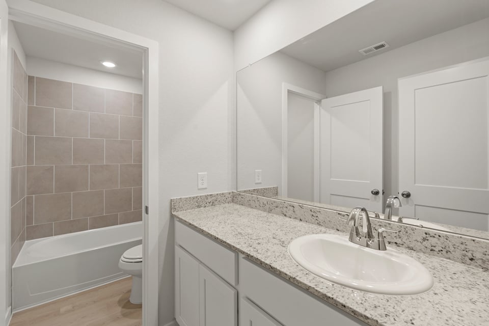 A bathroom with a marble countertop.