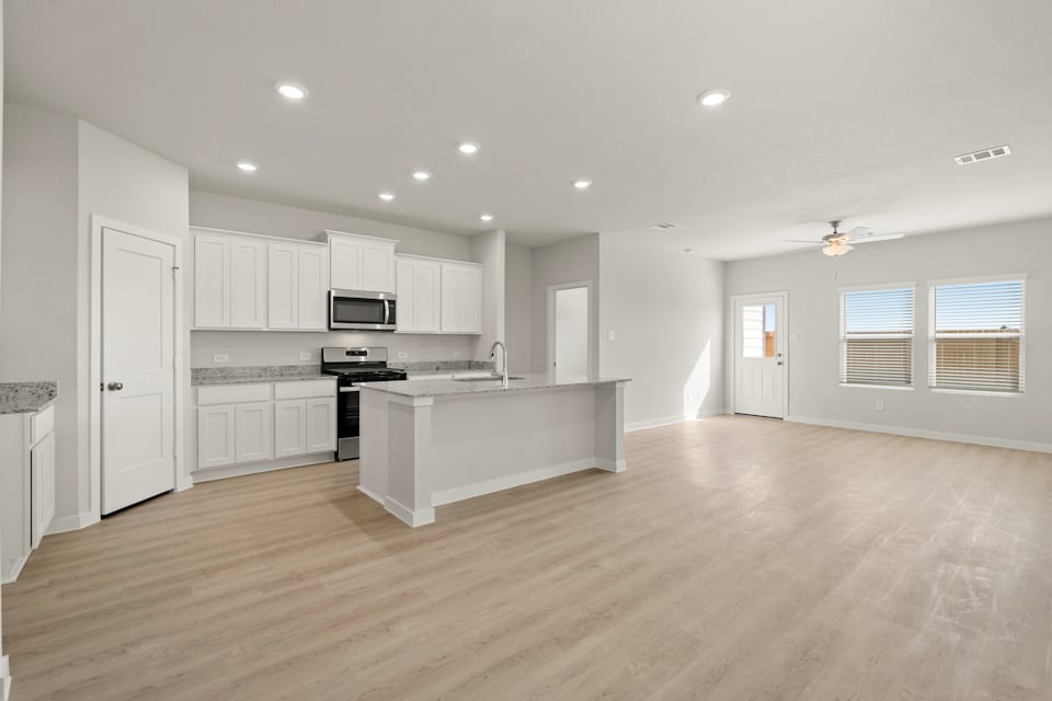 A large kitchen with white cabinets.