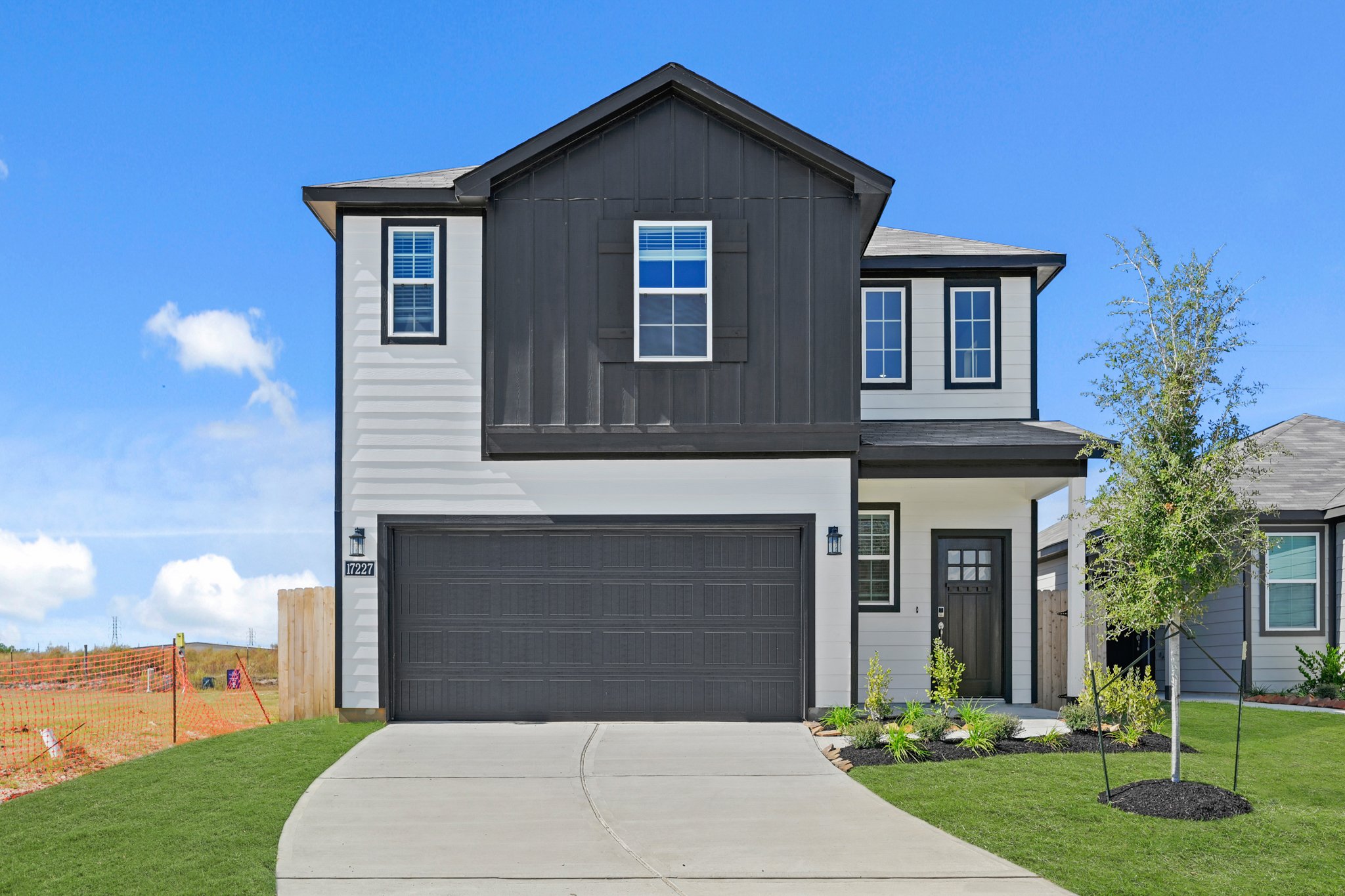 A grey house with a garage.