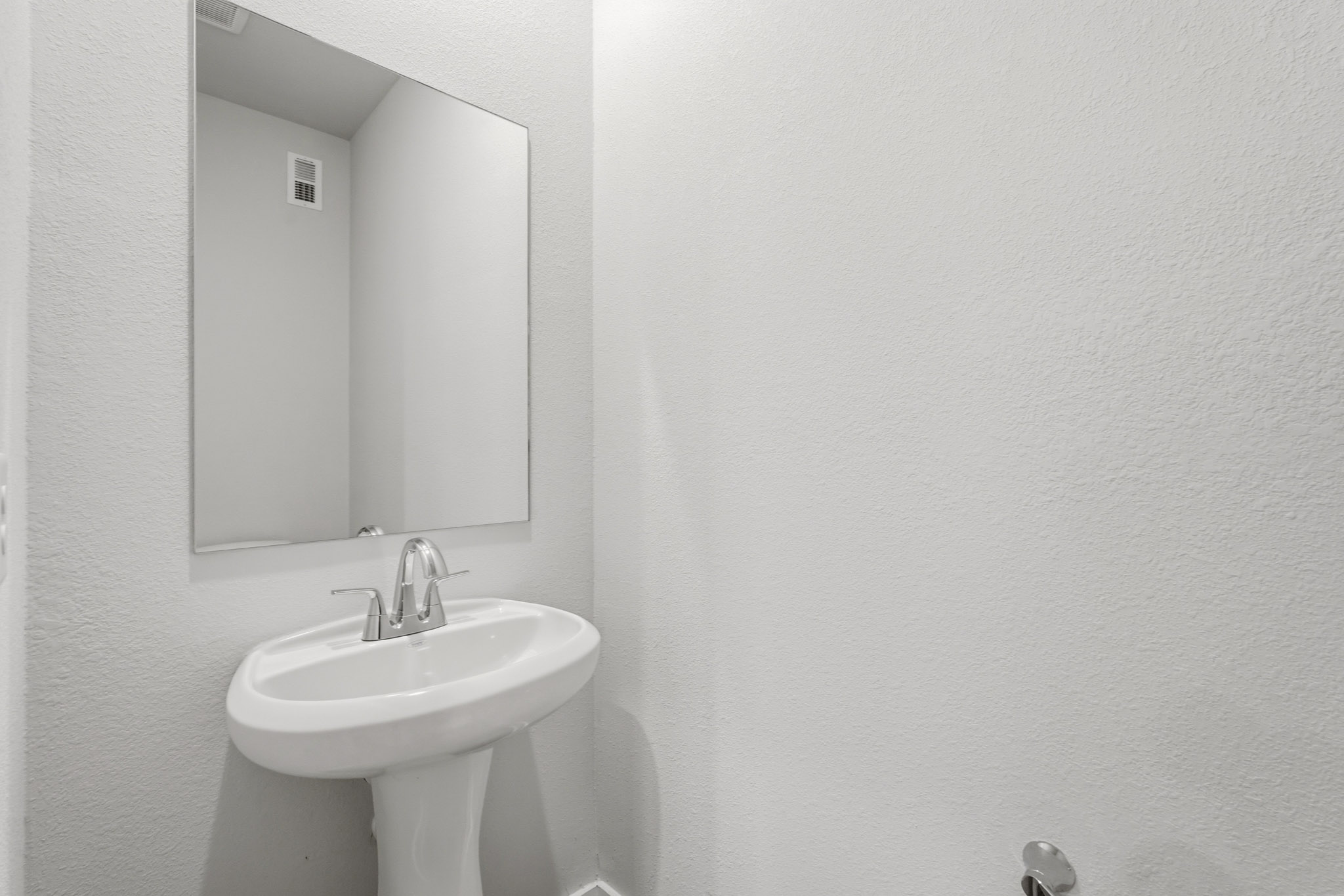 A bathroom with a sink and mirror.