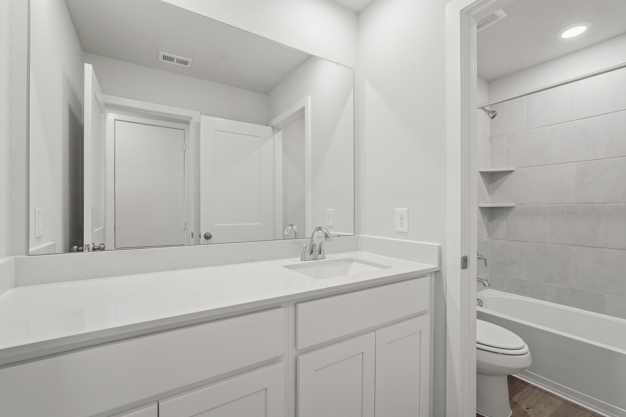 A bathroom with a tub sink and toilet.