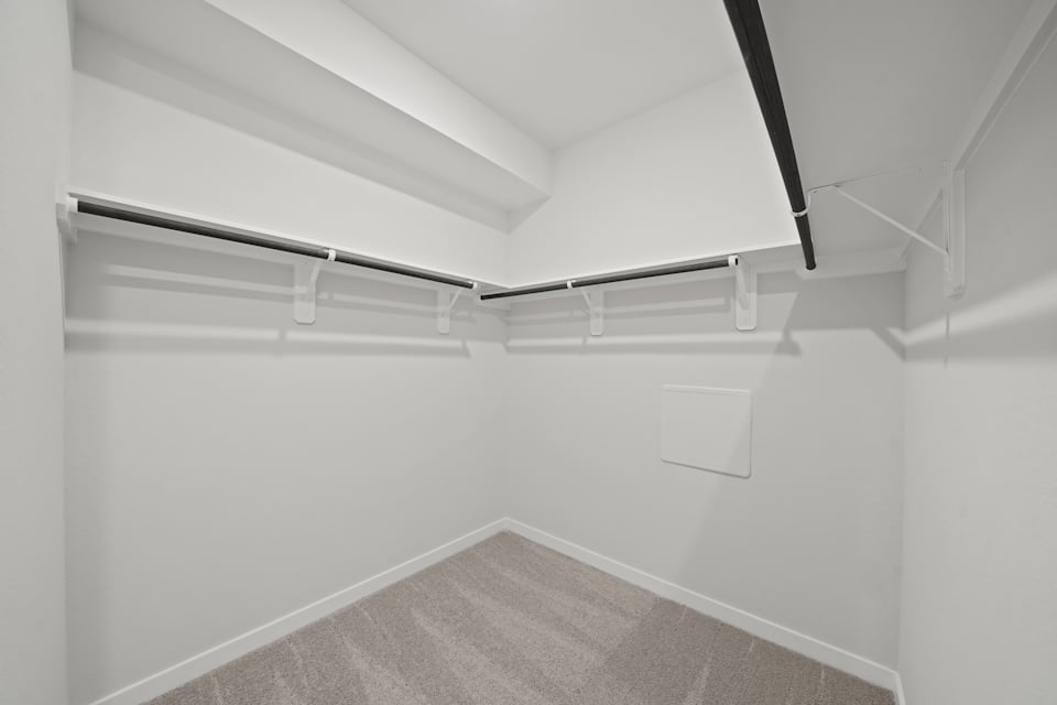 A white room with a carpet.