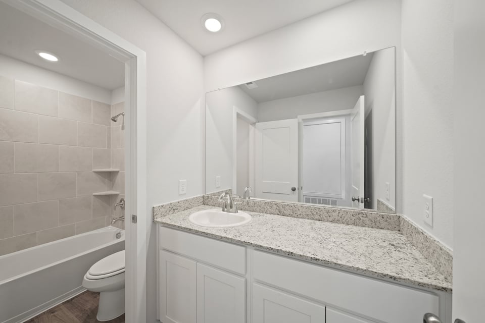 A bathroom with a marble countertop.