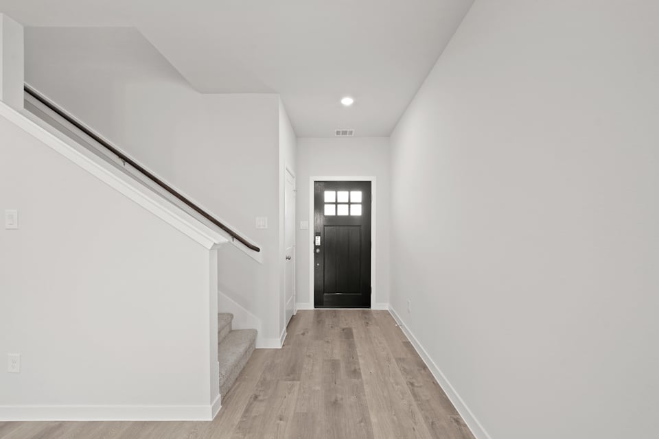 A hallway with white walls.