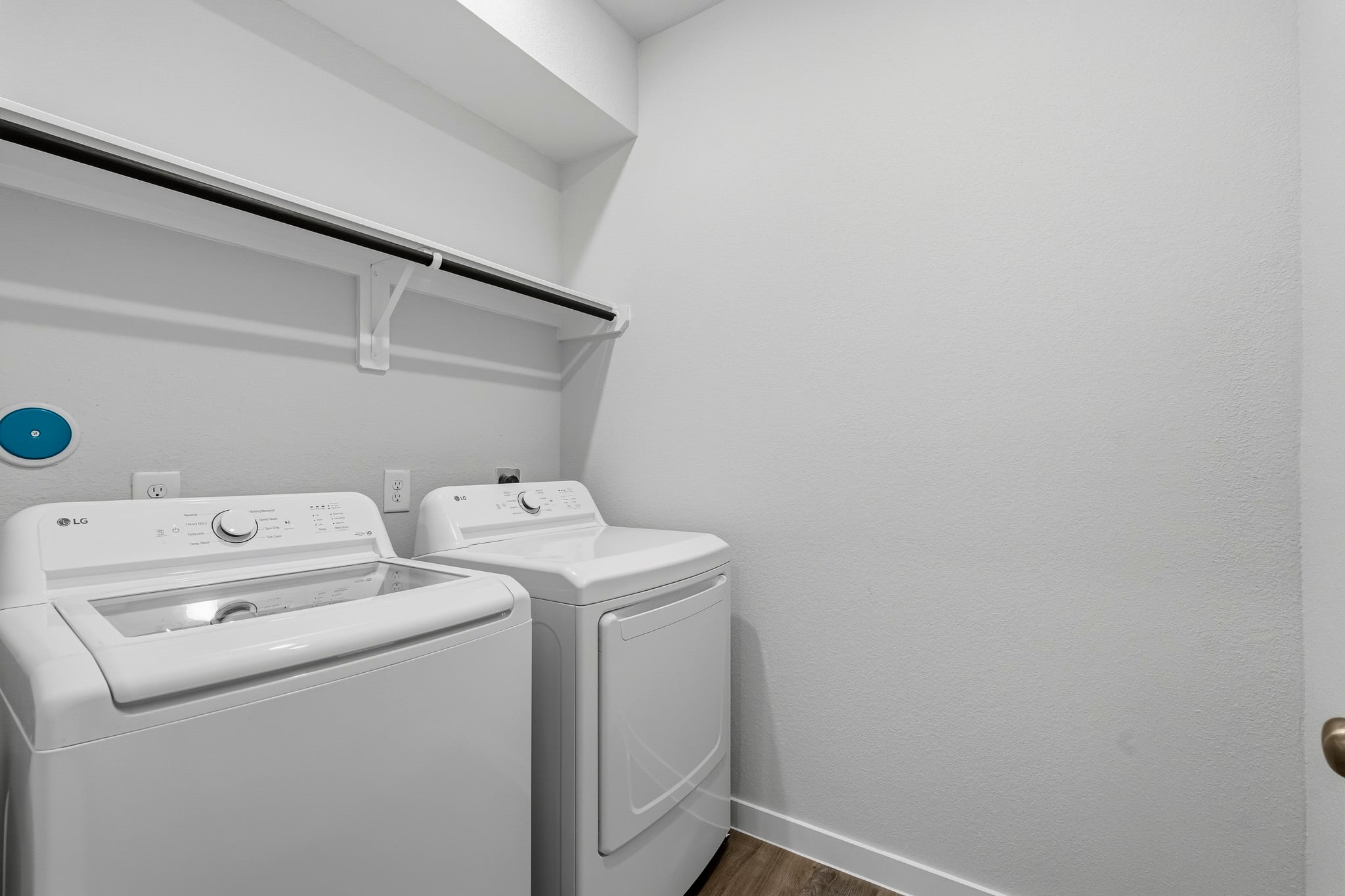 A washing machine and dryer in a room.