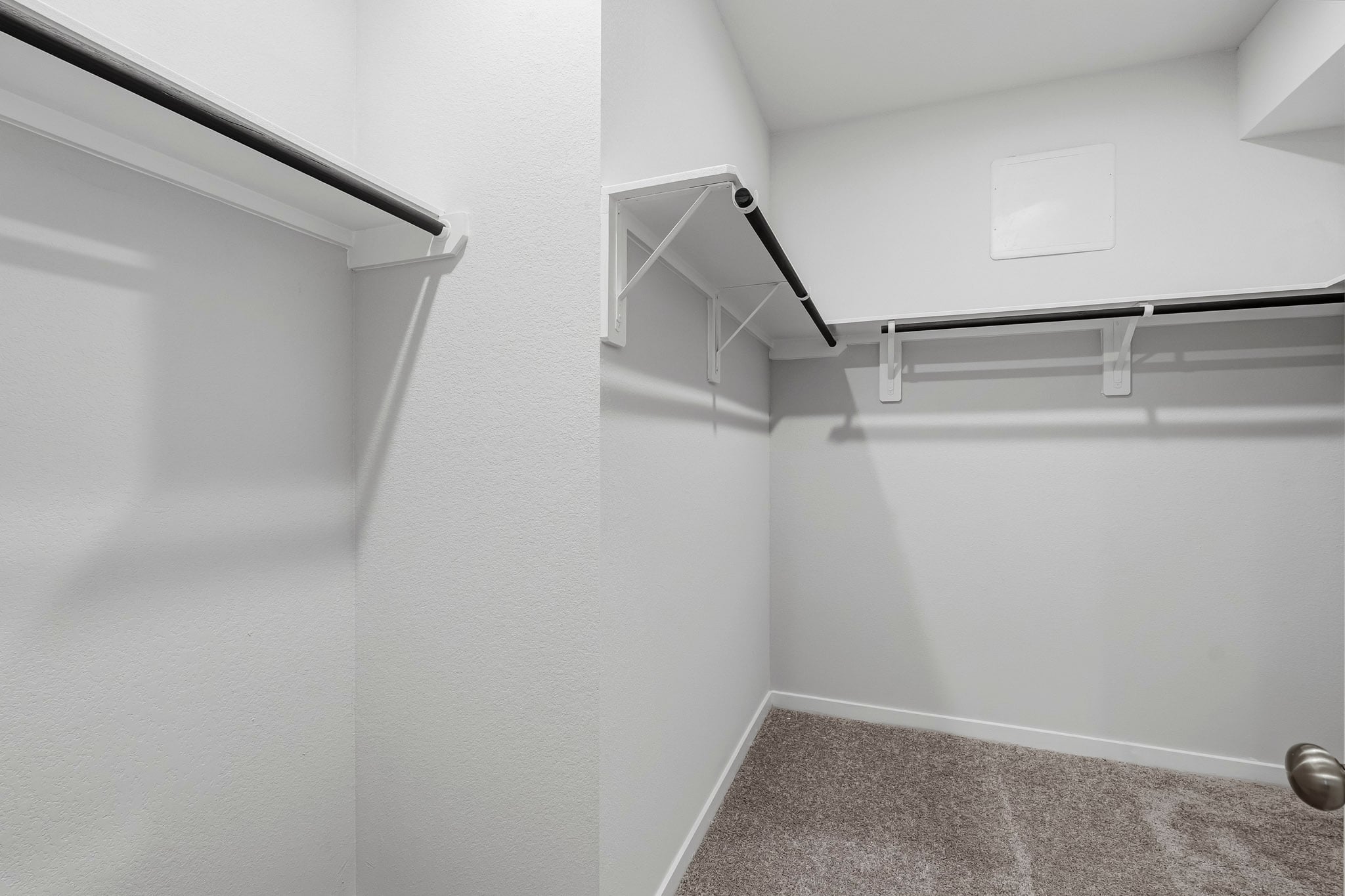 A white wall with a metal railing.