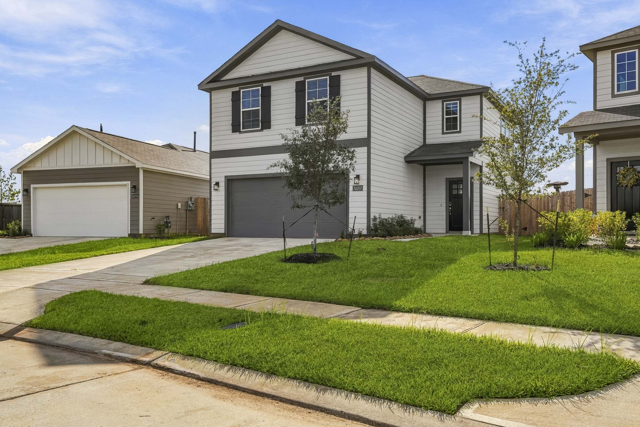A house with a driveway with Ronald Reagan Boyhood Home in the background.