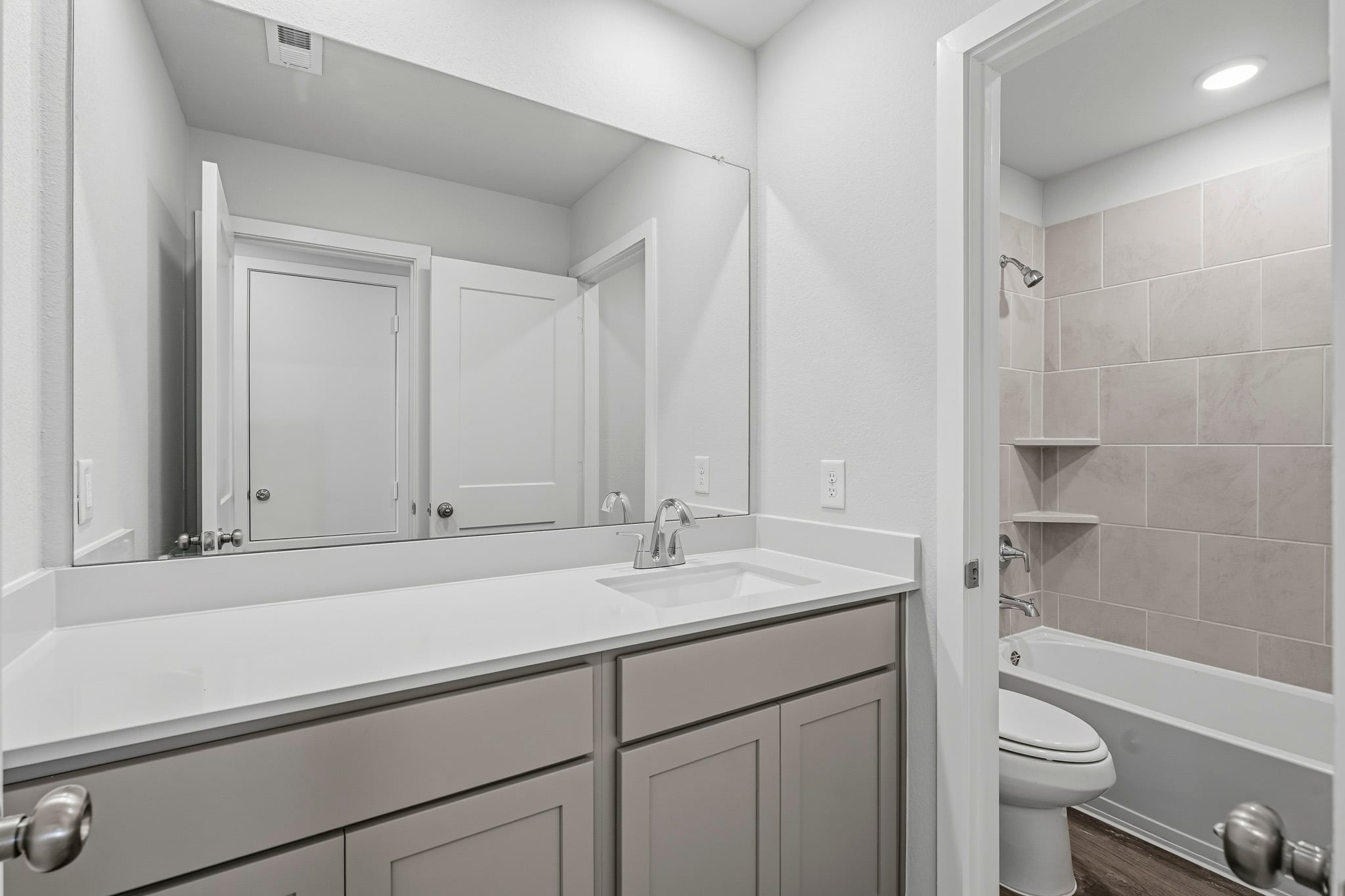 A bathroom with a tub sink and toilet.