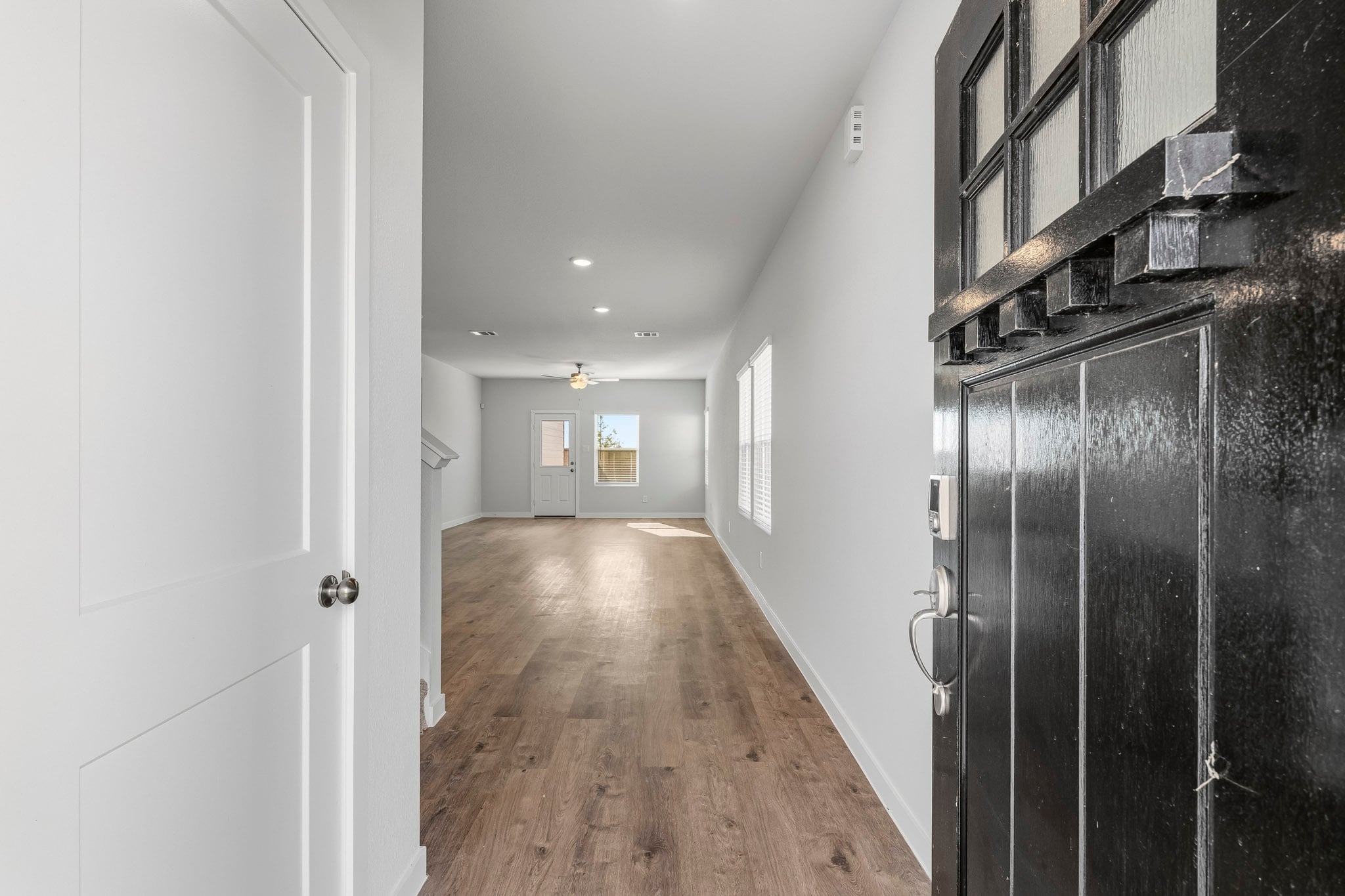 A hallway with black cabinets.